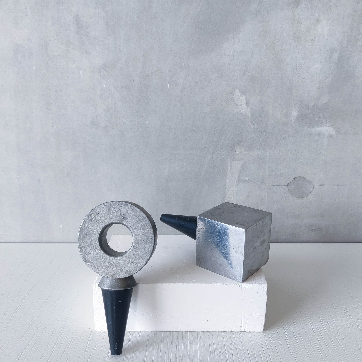 Pair of vintage cast aluminium wine bottle stoppers tops modernist geometric form
