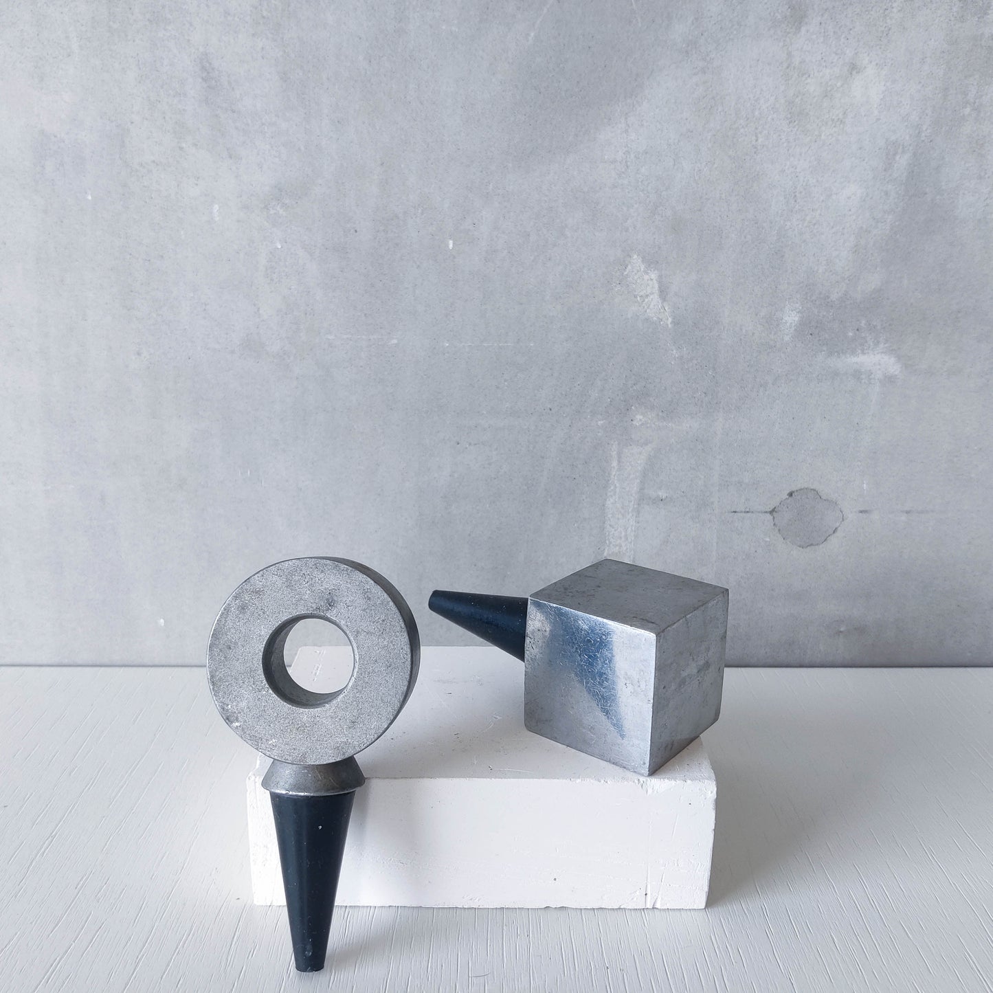 Pair of vintage cast aluminium wine bottle stoppers tops modernist geometric form