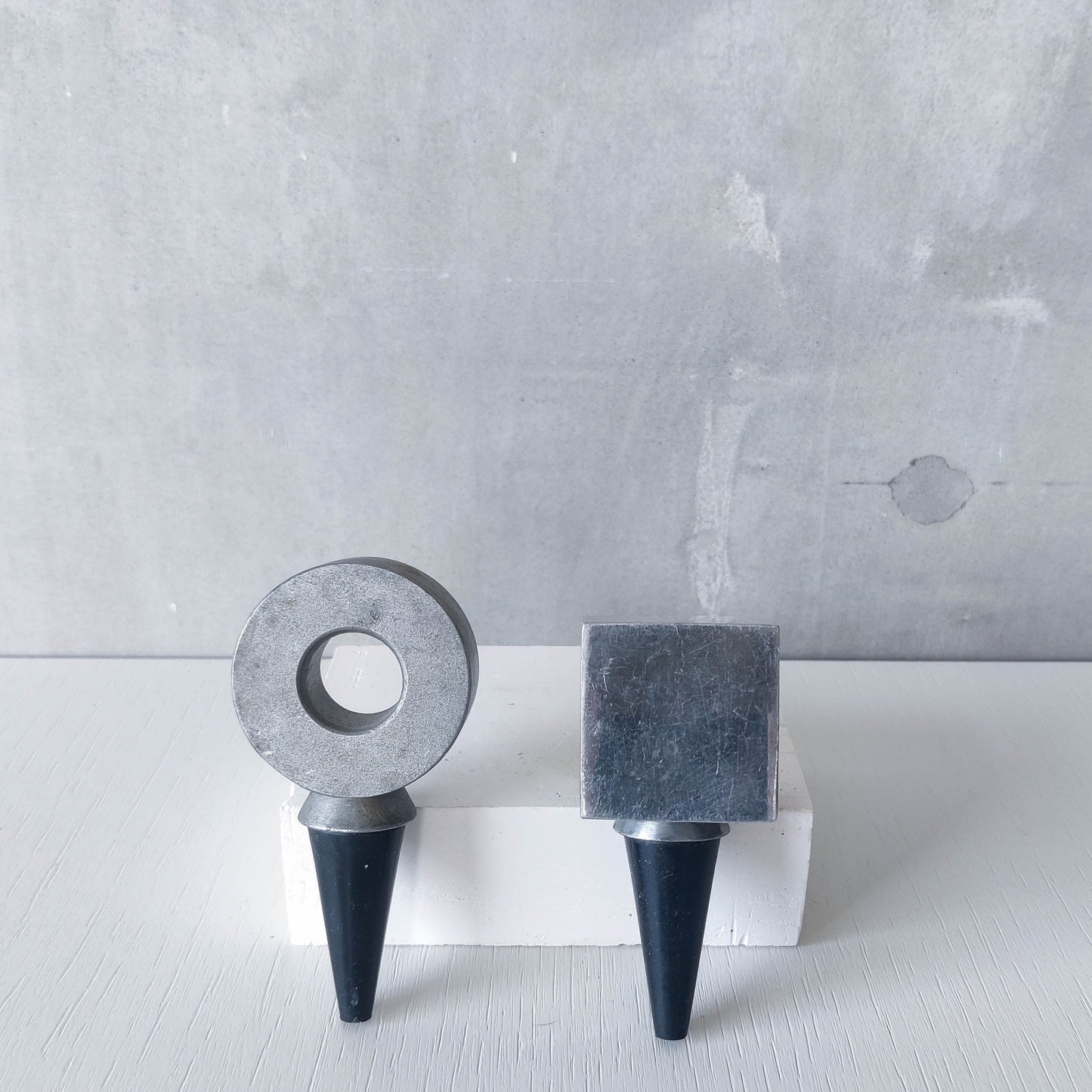 Pair of vintage cast aluminium wine bottle stoppers tops modernist geometric form