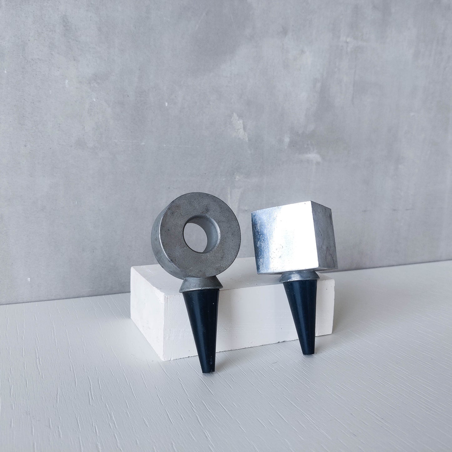 Pair of vintage cast aluminium wine bottle stoppers tops modernist geometric form