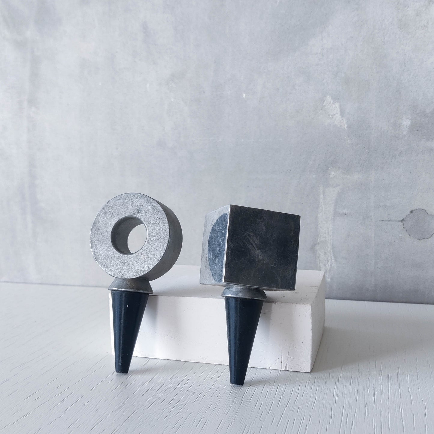 Pair of vintage cast aluminium wine bottle stoppers tops modernist geometric form