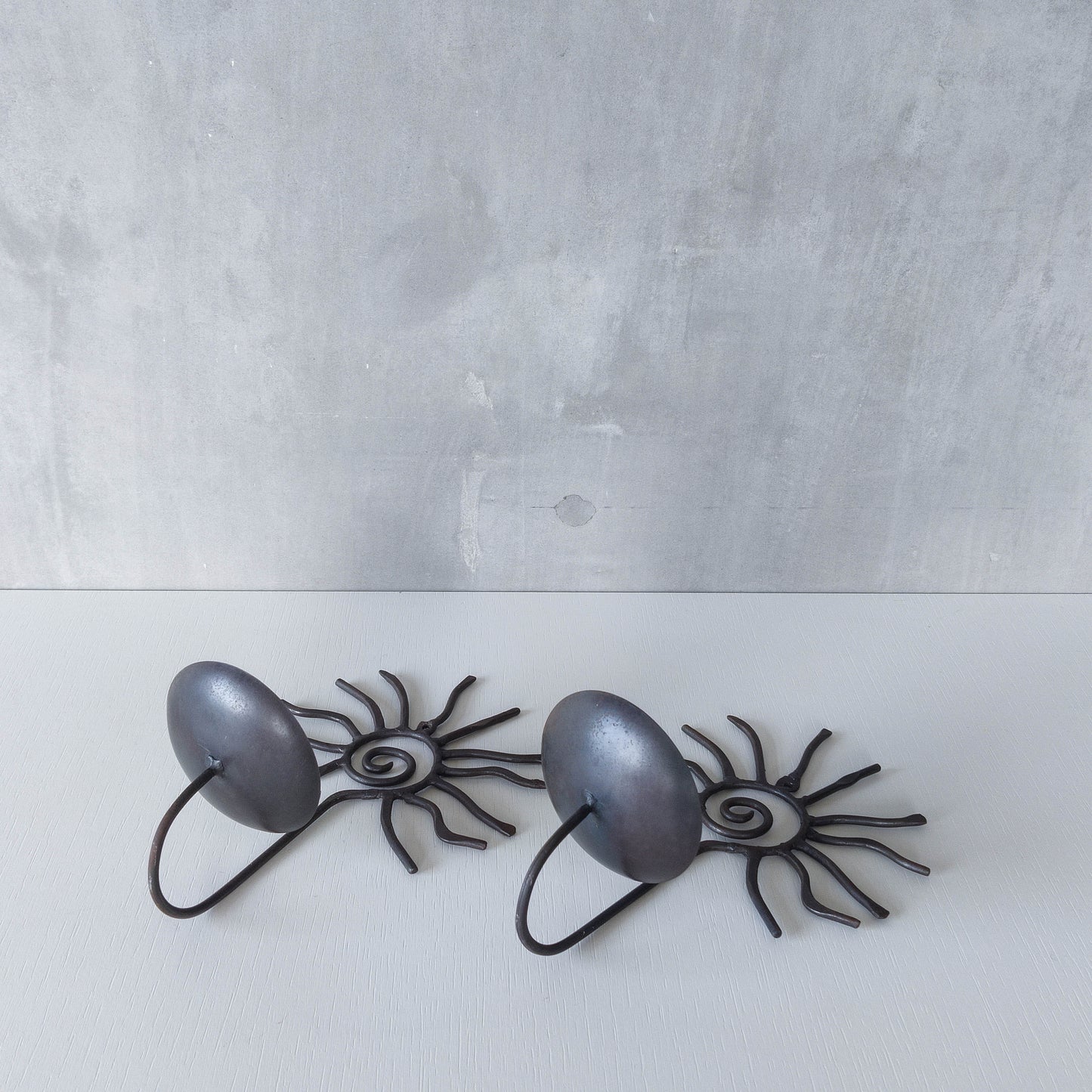 Pair of vintage 90s welded steel sun ray spiral swirl candle wall sconces