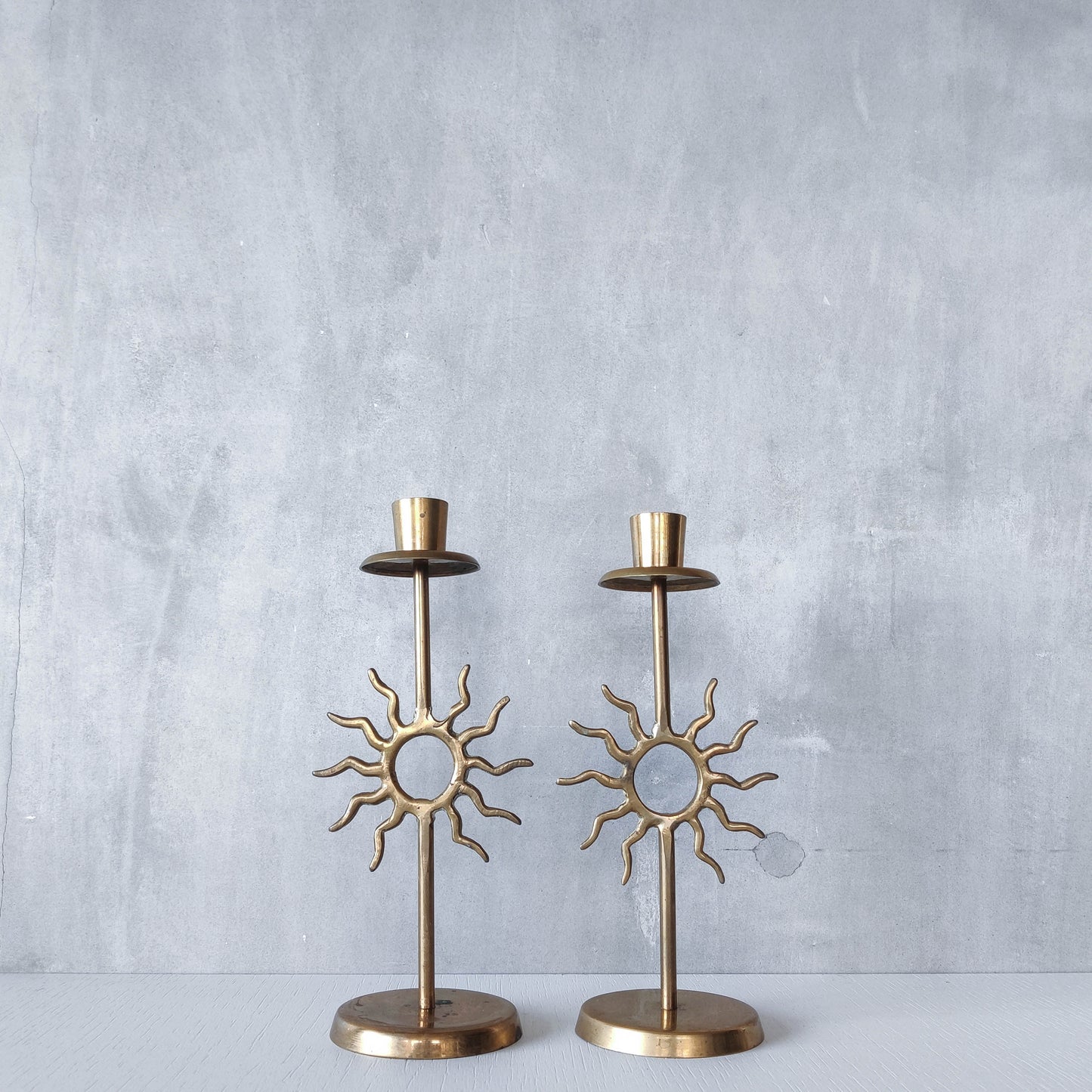 Vintage 1990s pair of cast brass Fornasetti style sun celestial candle holders