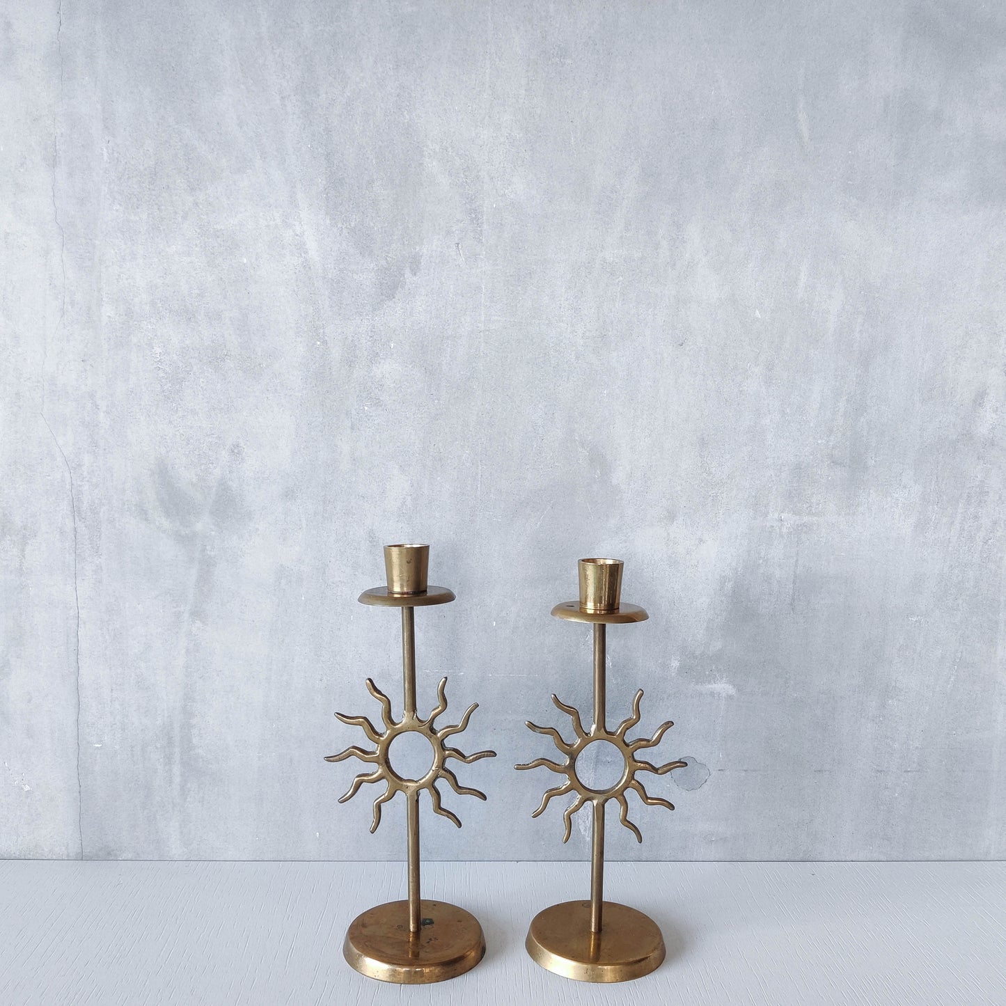 Vintage 1990s pair of cast brass Fornasetti style sun celestial candle holders