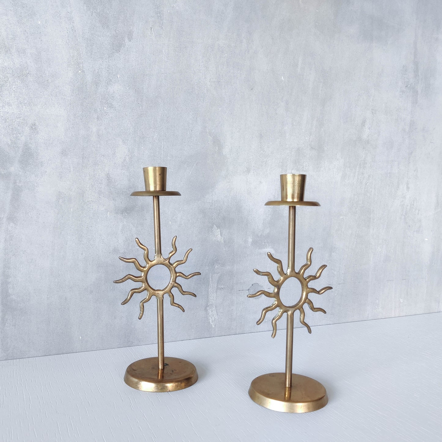 Vintage 1990s pair of cast brass Fornasetti style sun celestial candle holders