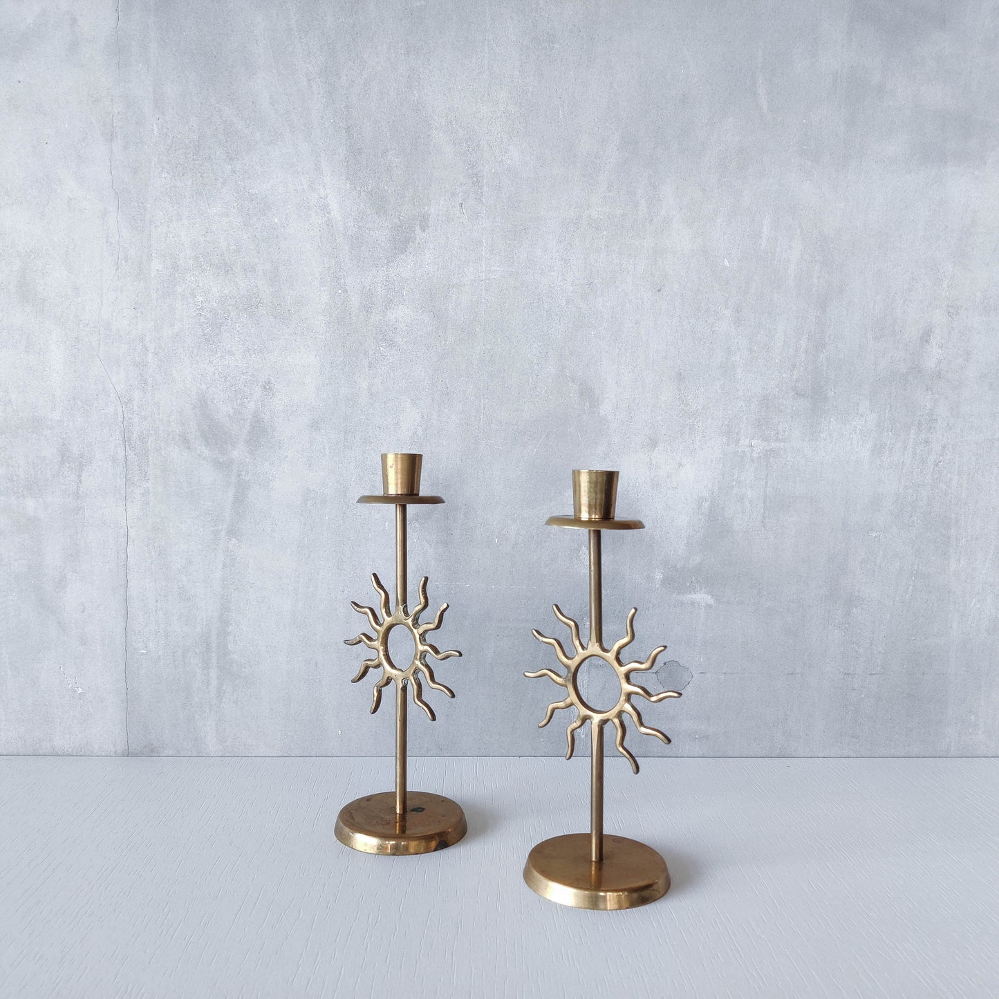 Vintage 1990s pair of cast brass Fornasetti style sun celestial candle holders
