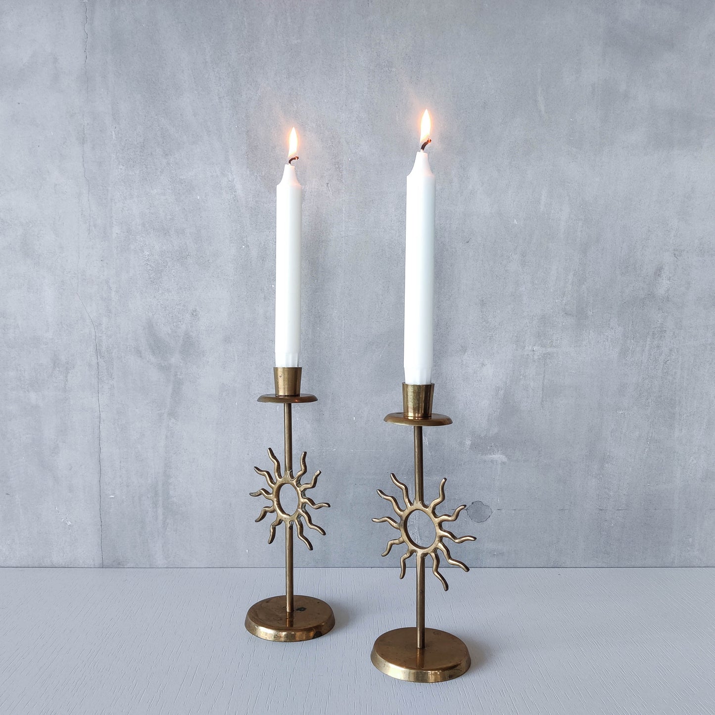 Vintage 1990s pair of cast brass Fornasetti style sun celestial candle holders