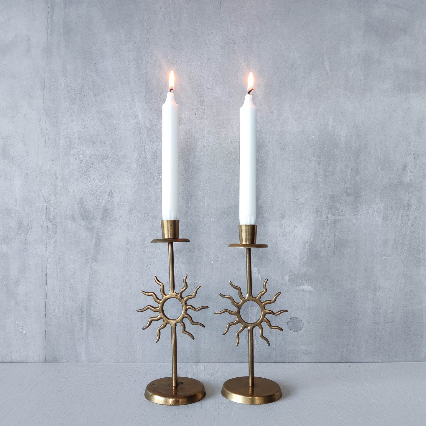 Vintage 1990s pair of cast brass Fornasetti style sun celestial candle holders