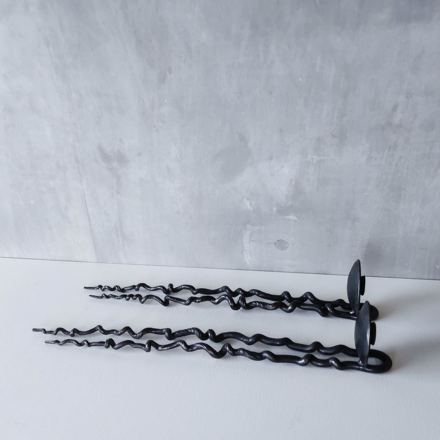 Pair of wrought iron blacksmith made twisted sculptural candle wall sconces
