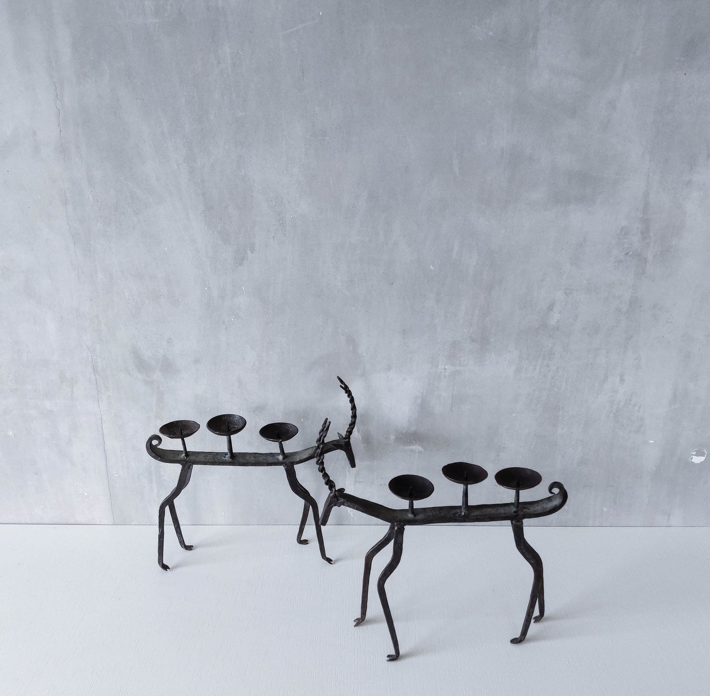 Pair of brutalist vintage wrought iron primitive antelope deer candelabras