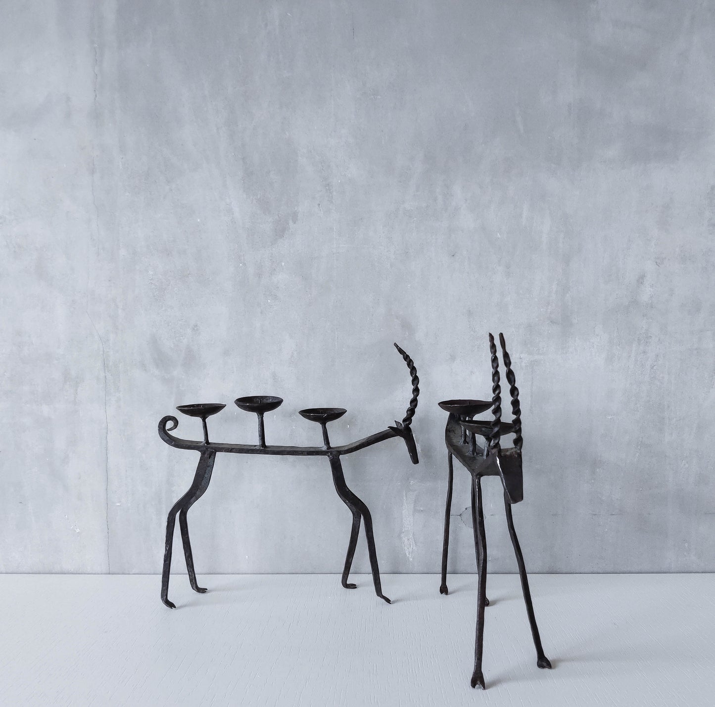 Pair of brutalist vintage wrought iron primitive antelope deer candelabras