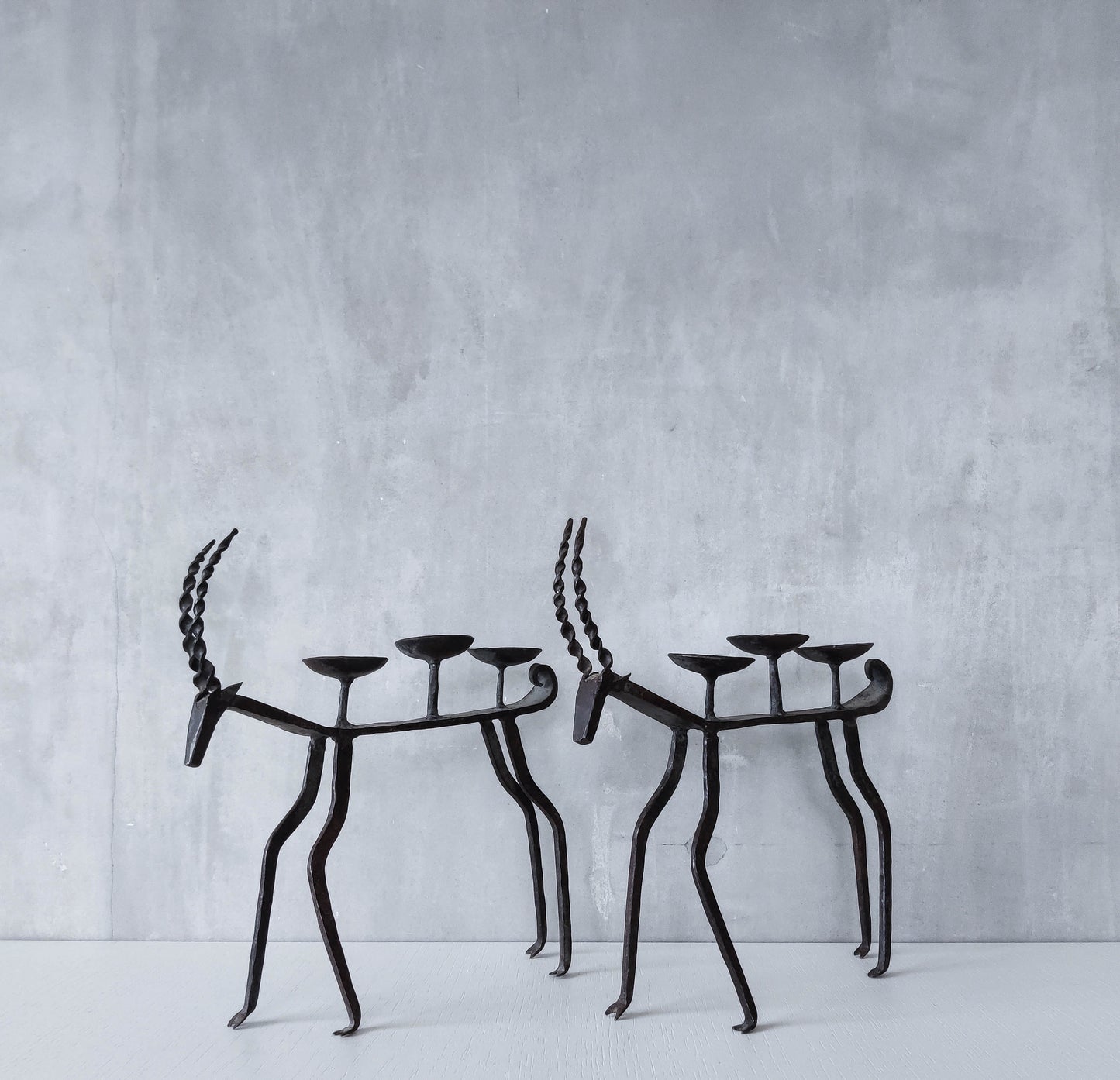 Pair of brutalist vintage wrought iron primitive antelope deer candelabras