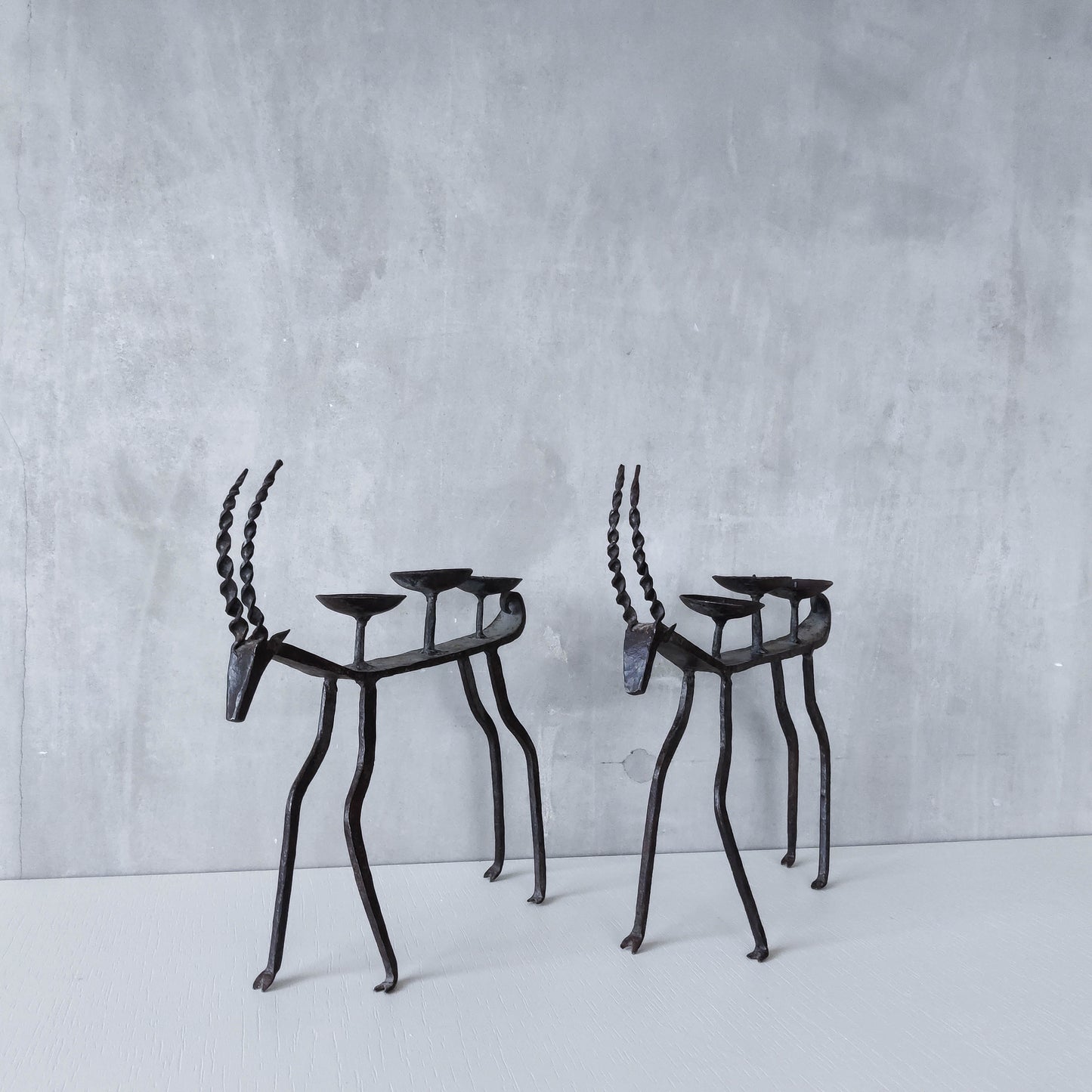Pair of brutalist vintage wrought iron primitive antelope deer candelabras