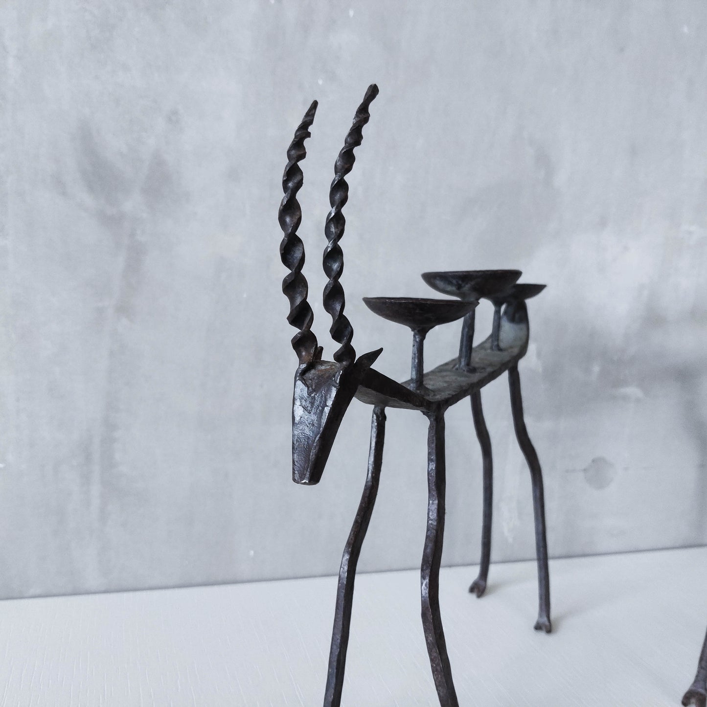 Pair of brutalist vintage wrought iron primitive antelope deer candelabras