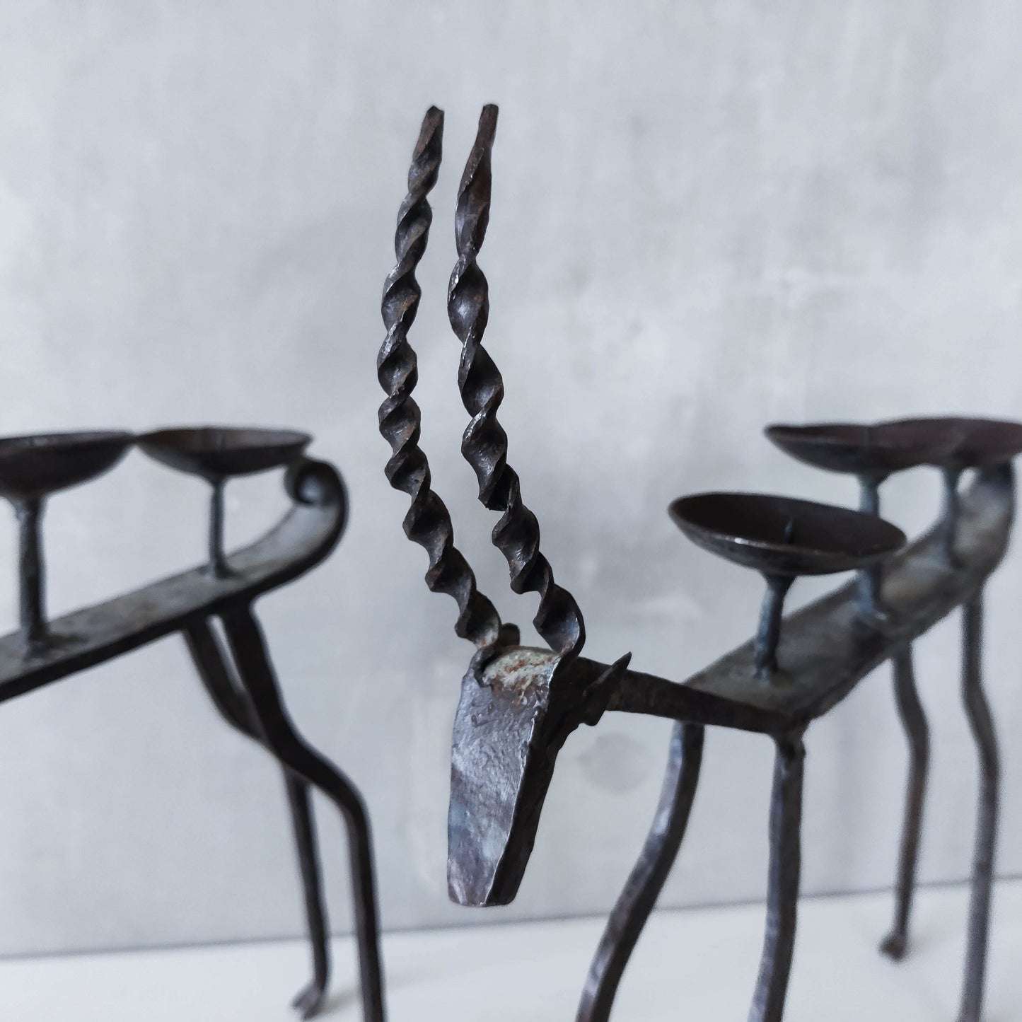 Pair of brutalist vintage wrought iron primitive antelope deer candelabras