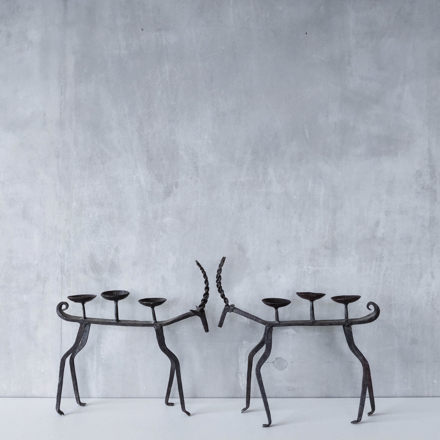 Pair of brutalist vintage wrought iron primitive antelope deer candelabras