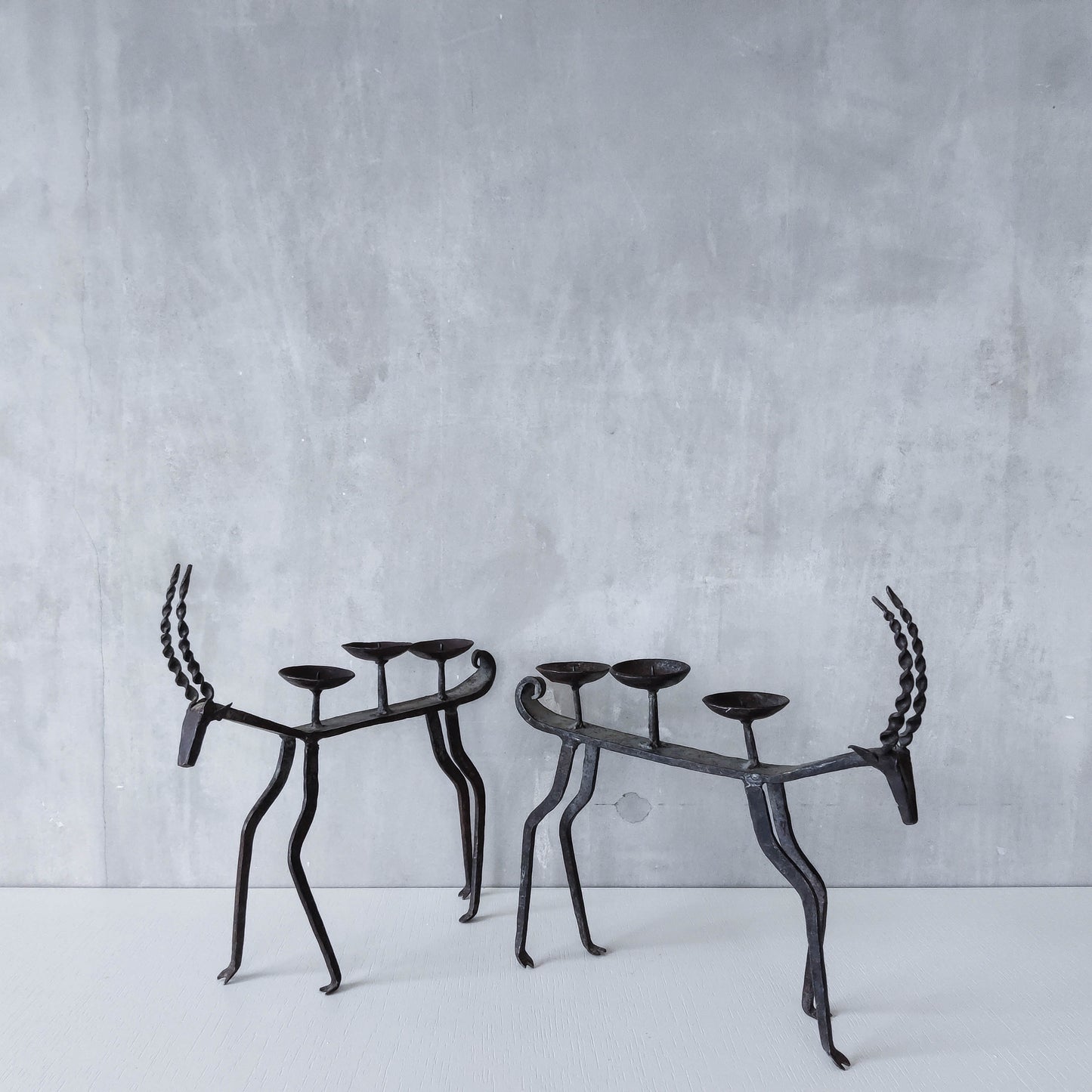 Pair of brutalist vintage wrought iron primitive antelope deer candelabras