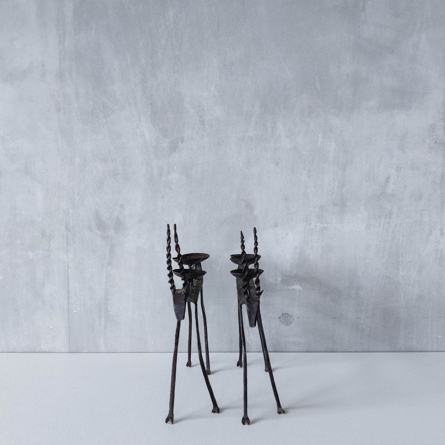 Pair of brutalist vintage wrought iron primitive antelope deer candelabras