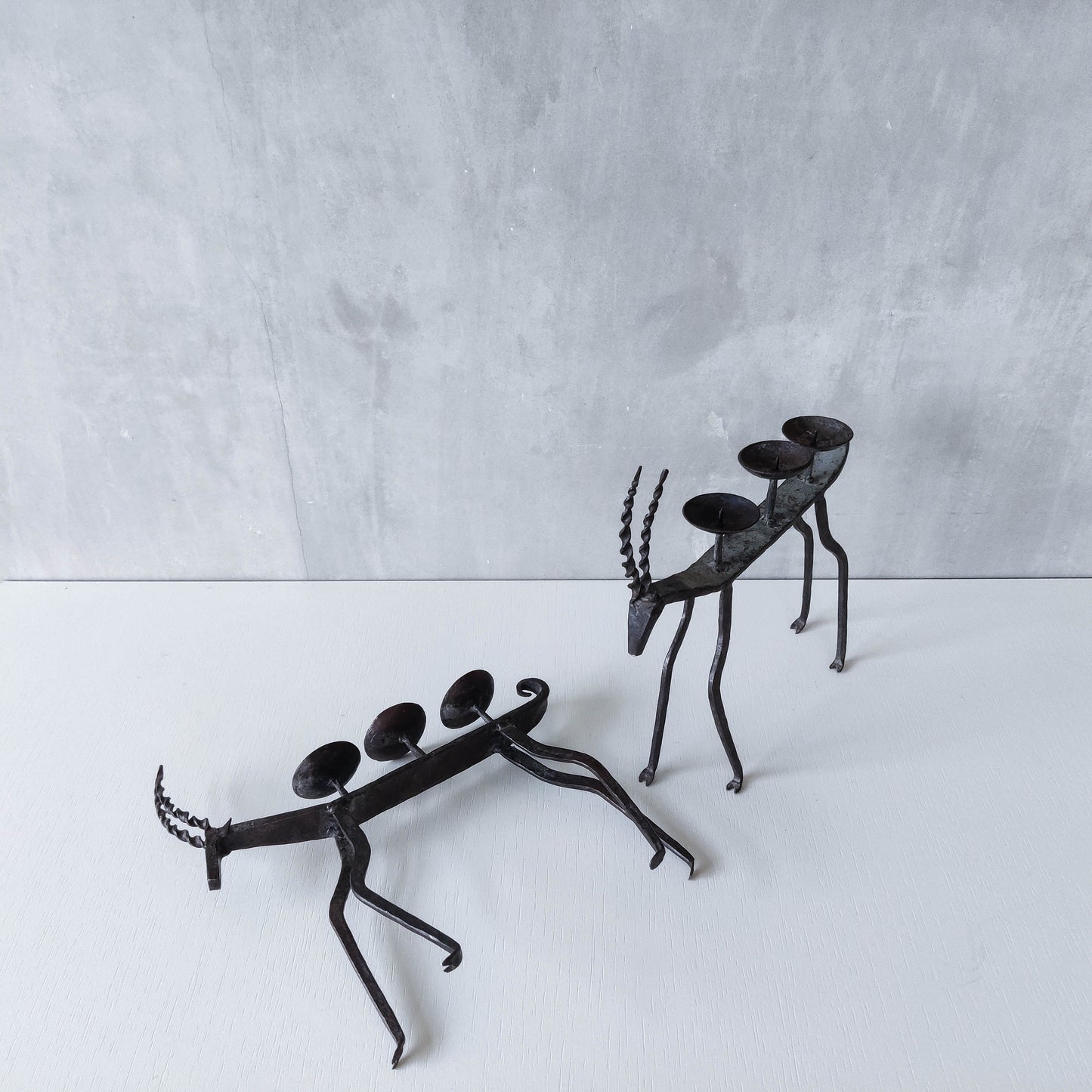 Pair of brutalist vintage wrought iron primitive antelope deer candelabras