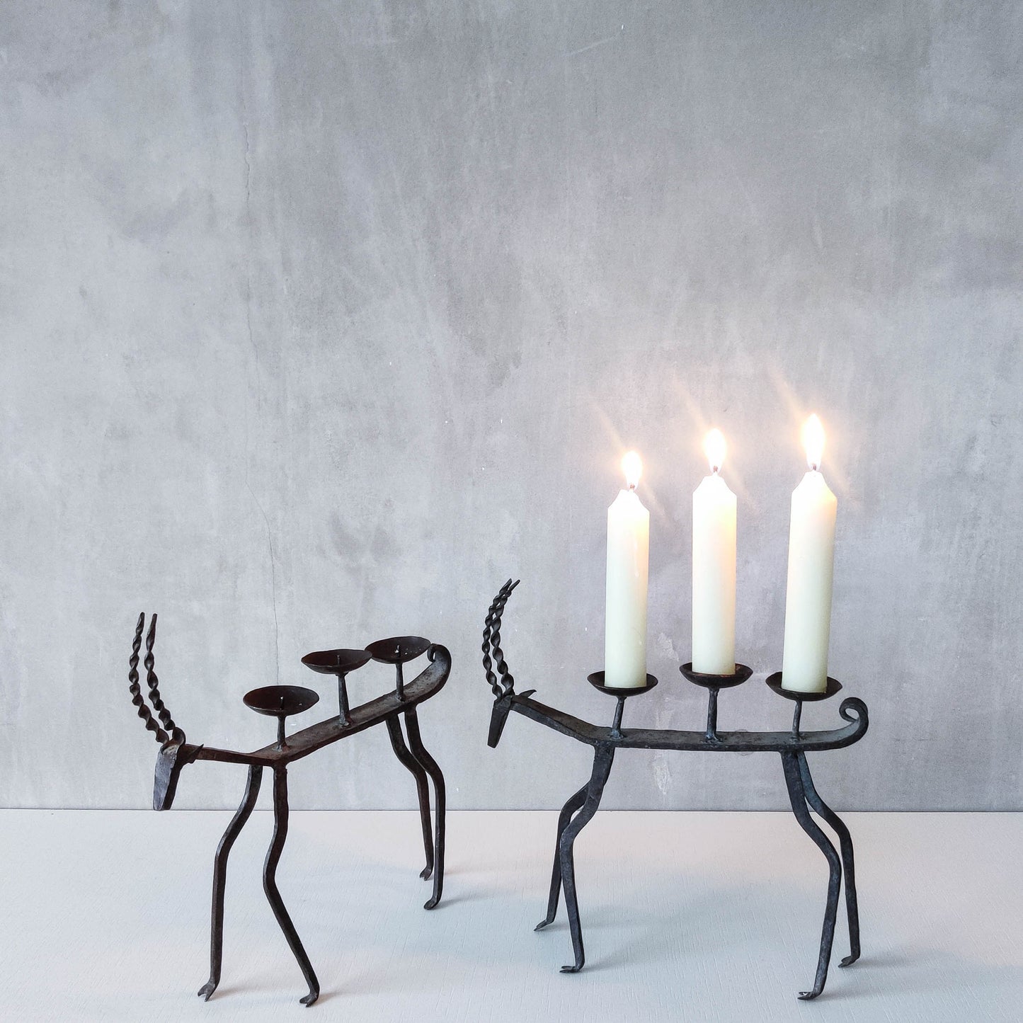 Pair of brutalist vintage wrought iron primitive antelope deer candelabras