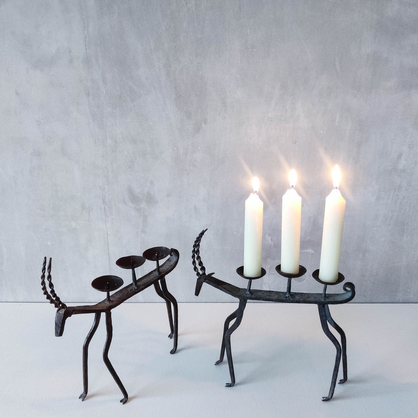 Pair of brutalist vintage wrought iron primitive antelope deer candelabras