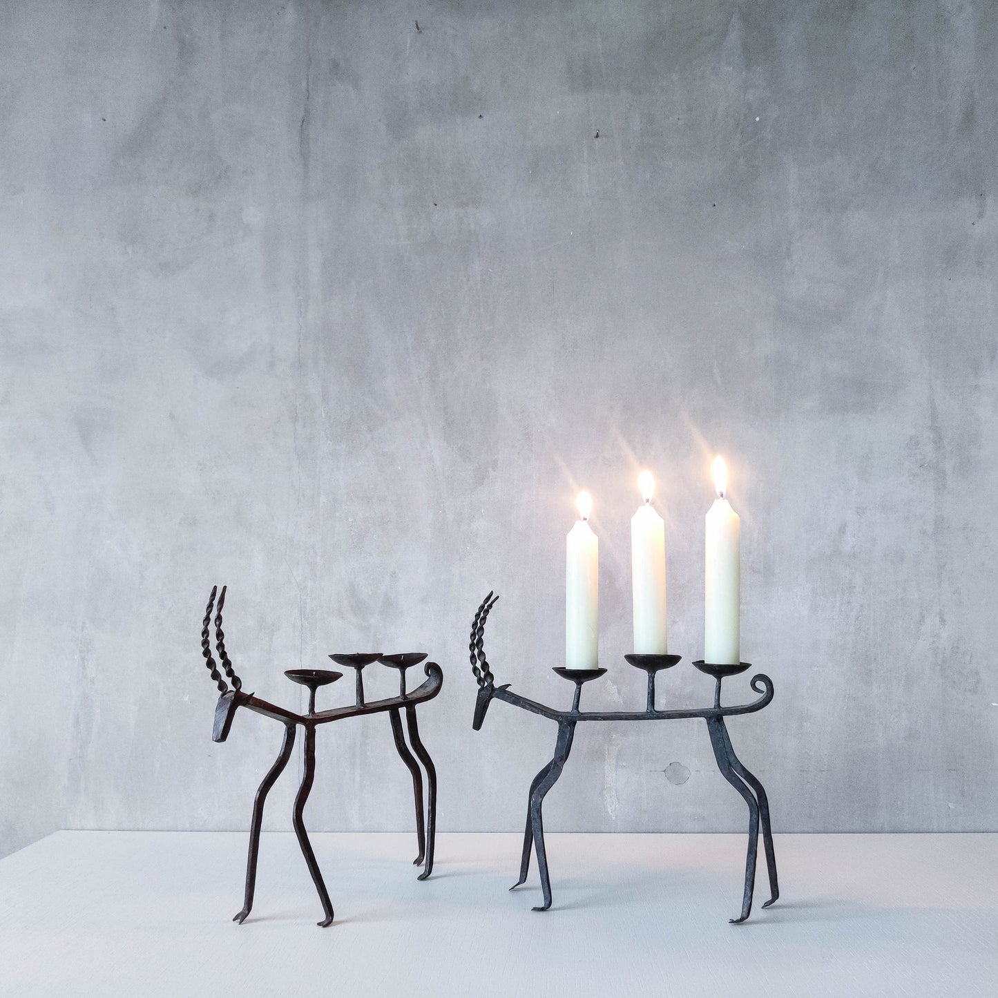 Pair of brutalist vintage wrought iron primitive antelope deer candelabras