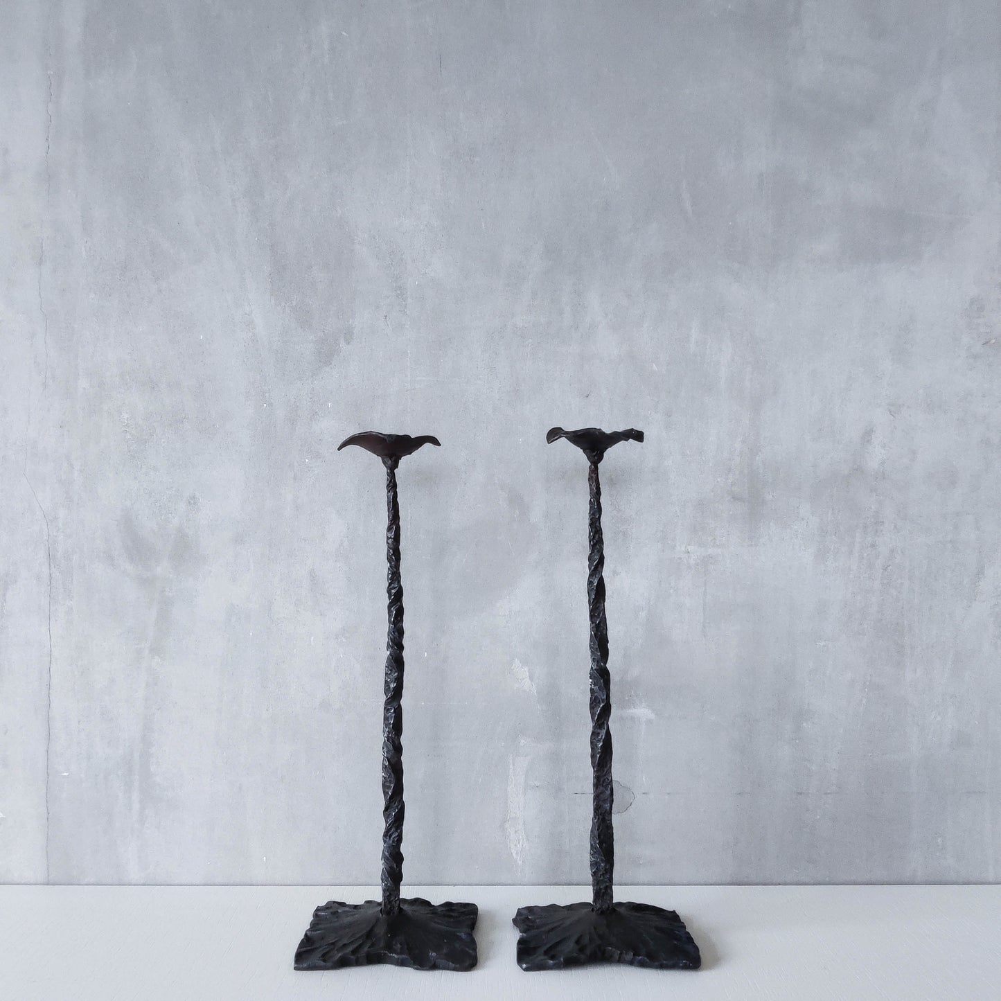 Pair of brutalist style hammered wrought iron blacksmith made pricket top candle holders