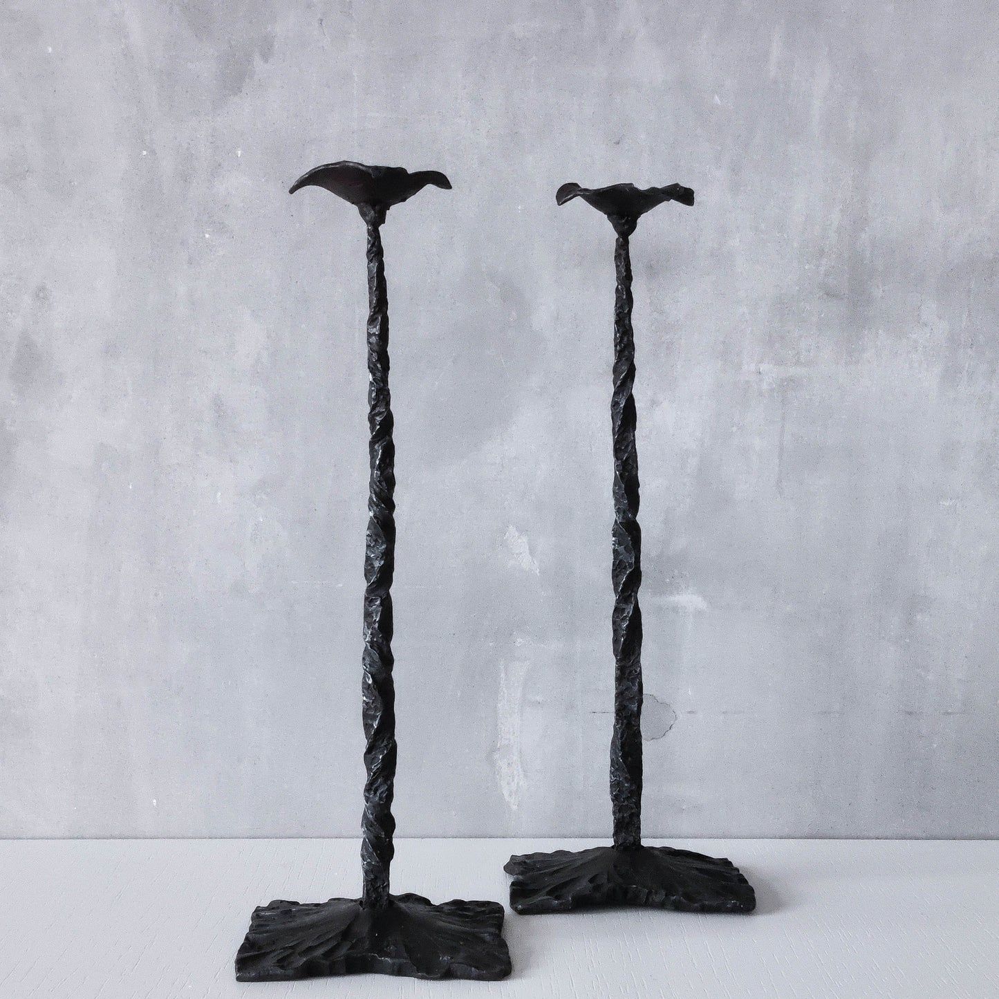 Pair of brutalist style hammered wrought iron blacksmith made pricket top candle holders