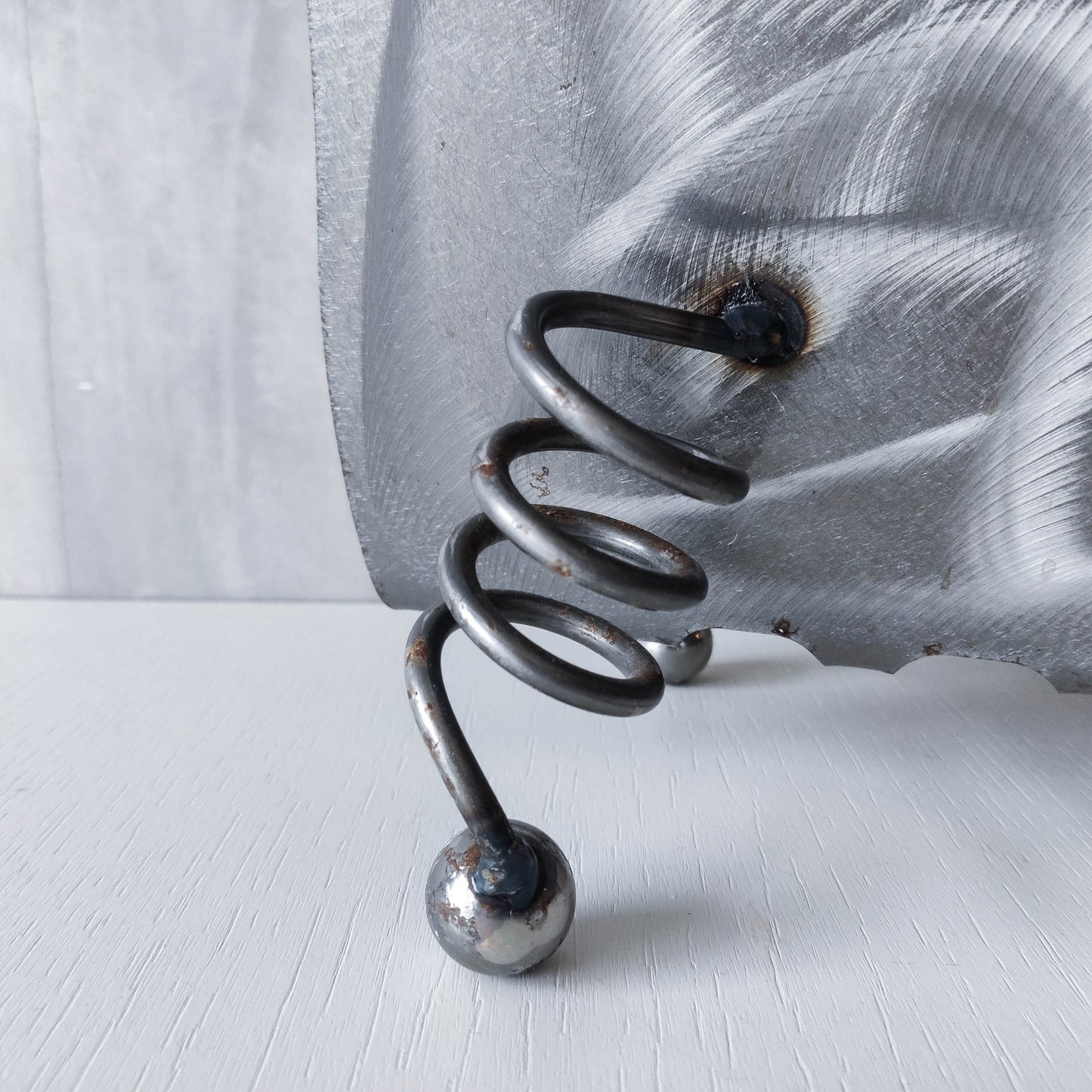 Vintage 1990s postmodern welded steel sculptural magazine rack with spiral ball feet