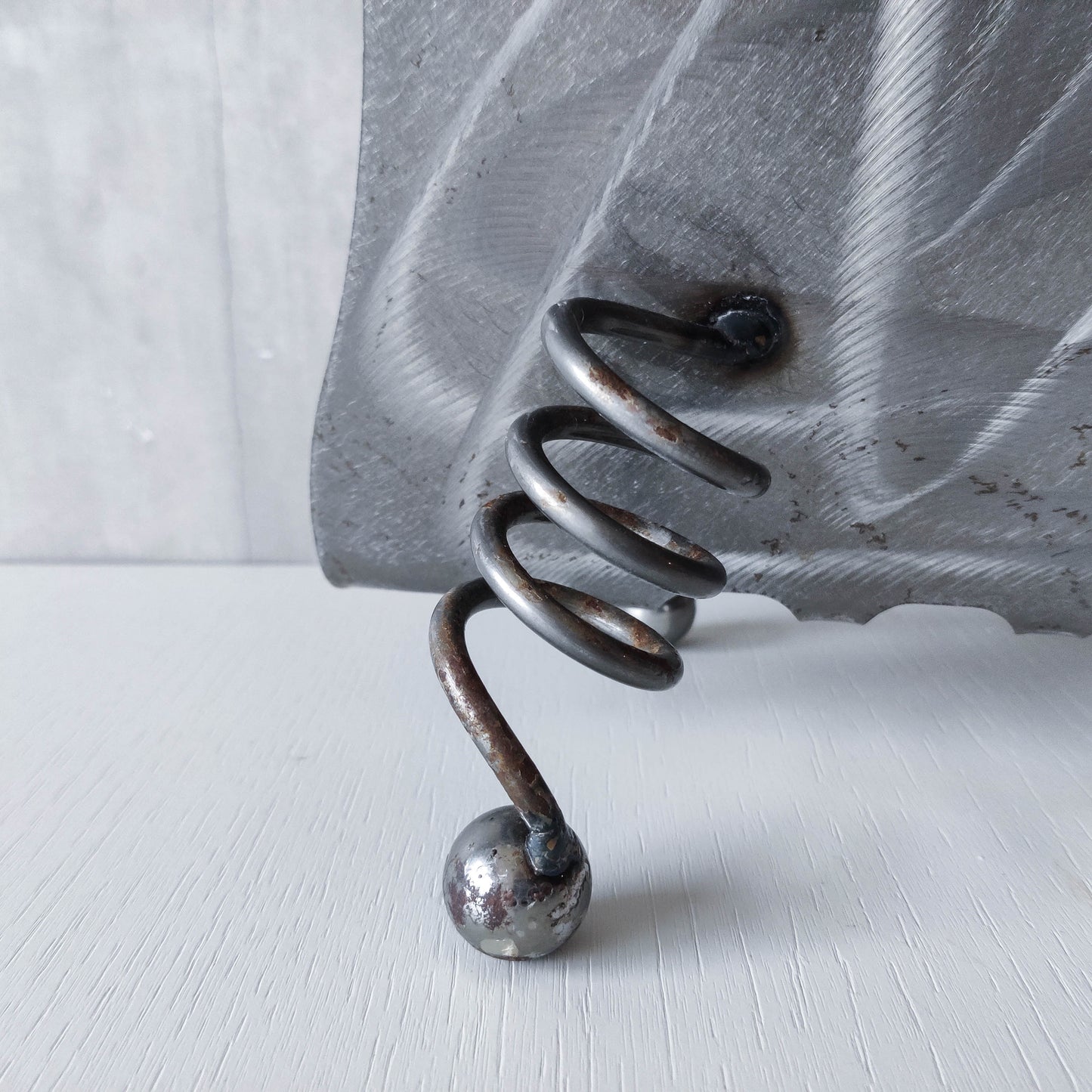 Vintage 1990s postmodern welded steel sculptural magazine rack with spiral ball feet