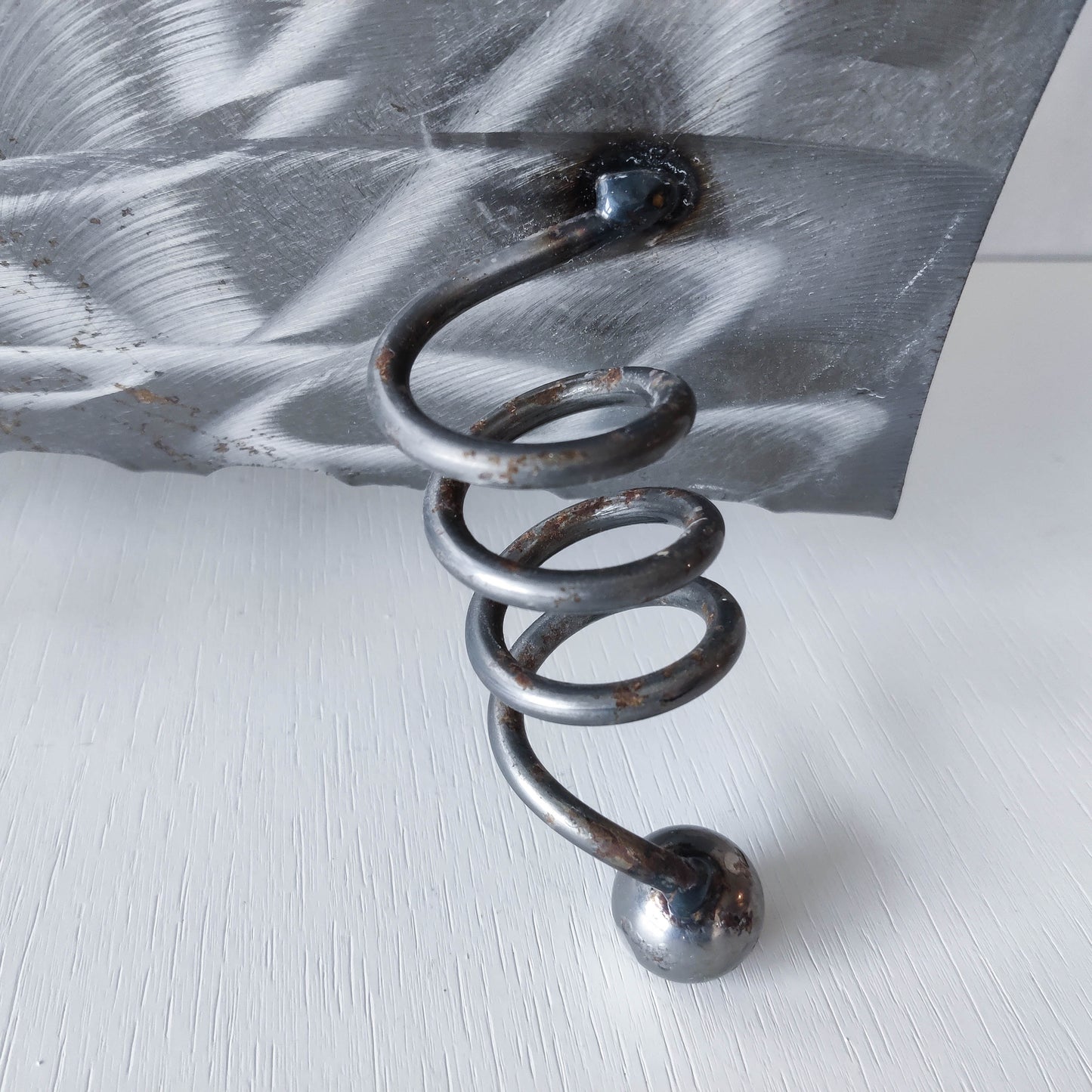 Vintage 1990s postmodern welded steel sculptural magazine rack with spiral ball feet