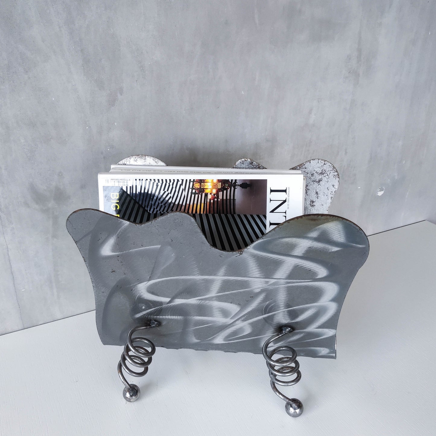 Vintage 1990s postmodern welded steel sculptural magazine rack with spiral ball feet