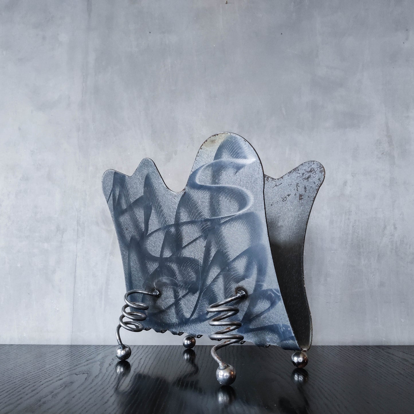 Vintage 1990s postmodern welded steel sculptural magazine rack with spiral ball feet