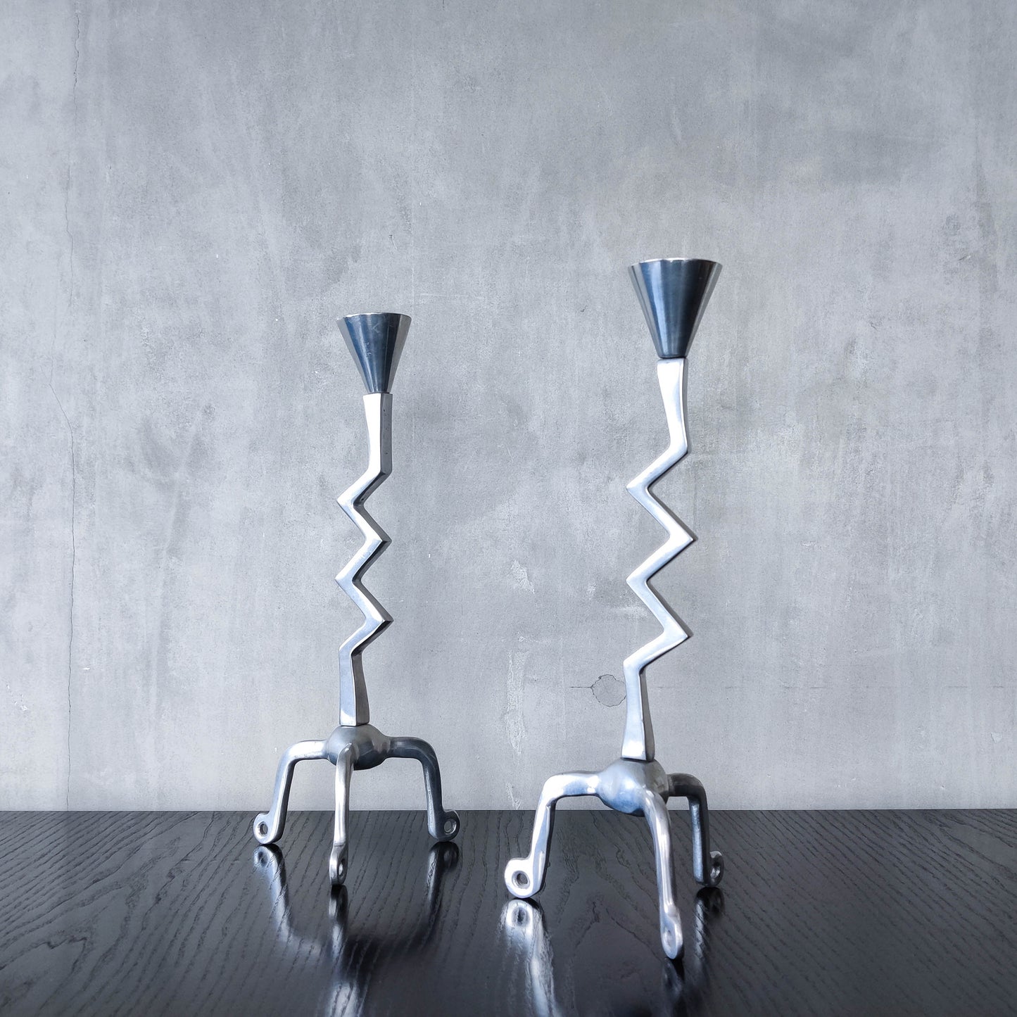 Pair of vintage postmodern chunky sculptural zigzag cast aluminium footed candle holders