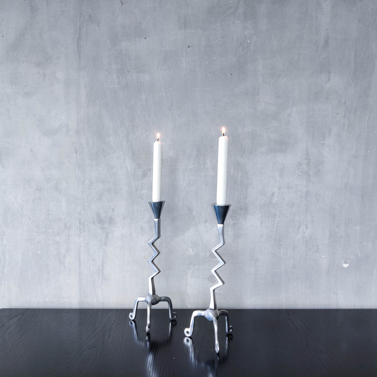 Pair of vintage postmodern chunky sculptural zigzag cast aluminium footed candle holders