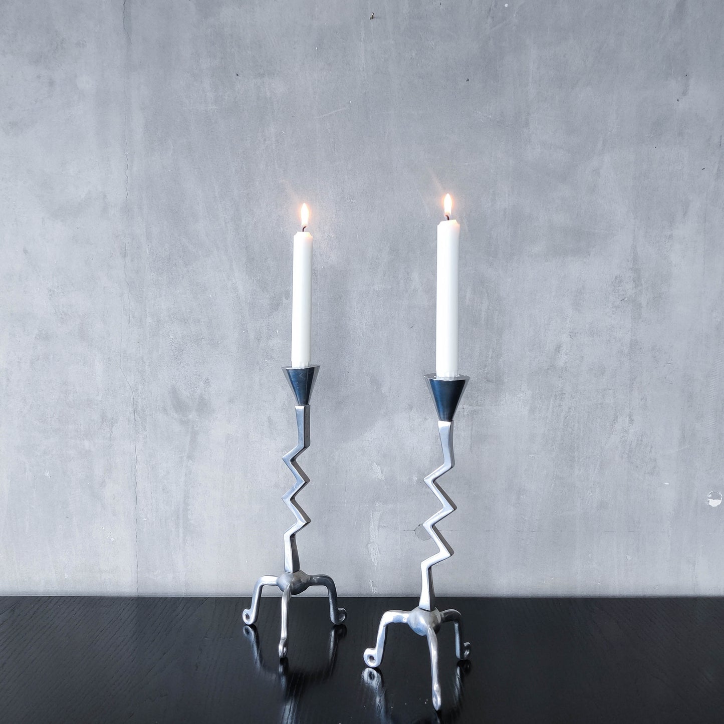 Pair of vintage postmodern chunky sculptural zigzag cast aluminium footed candle holders