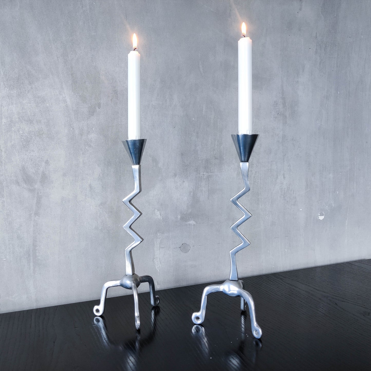 Pair of vintage postmodern chunky sculptural zigzag cast aluminium footed candle holders