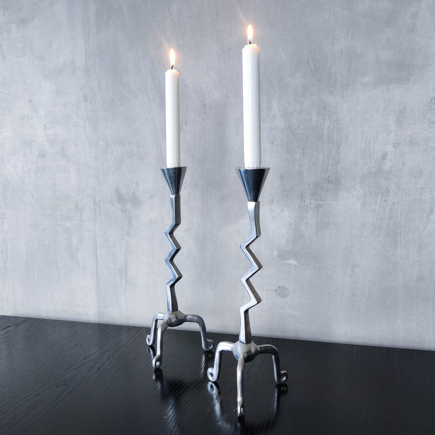 Pair of vintage postmodern chunky sculptural zigzag cast aluminium footed candle holders
