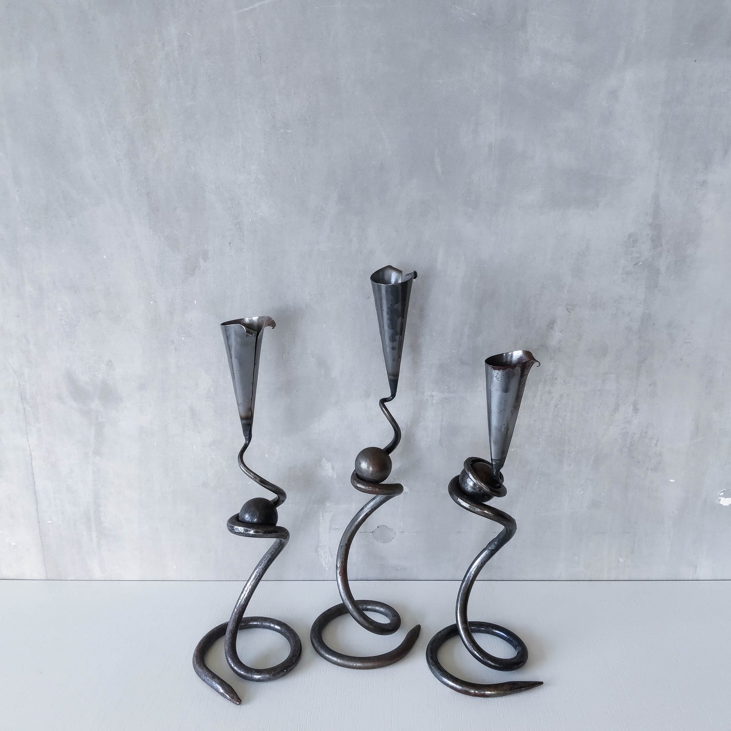 Trio of sculptural handmade wrought iron welded steel candle holders with steel balls