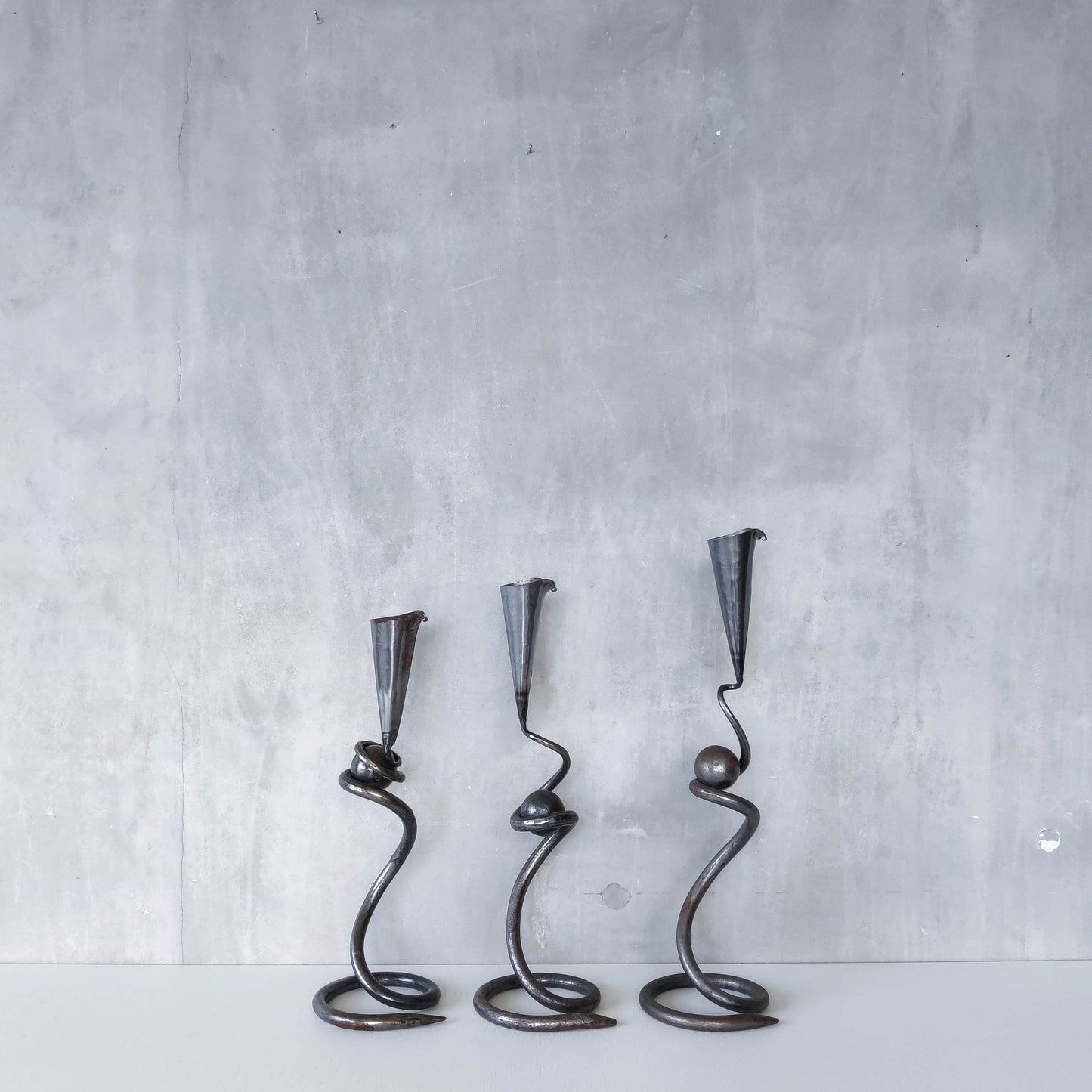 Trio of sculptural handmade wrought iron welded steel candle holders with steel balls