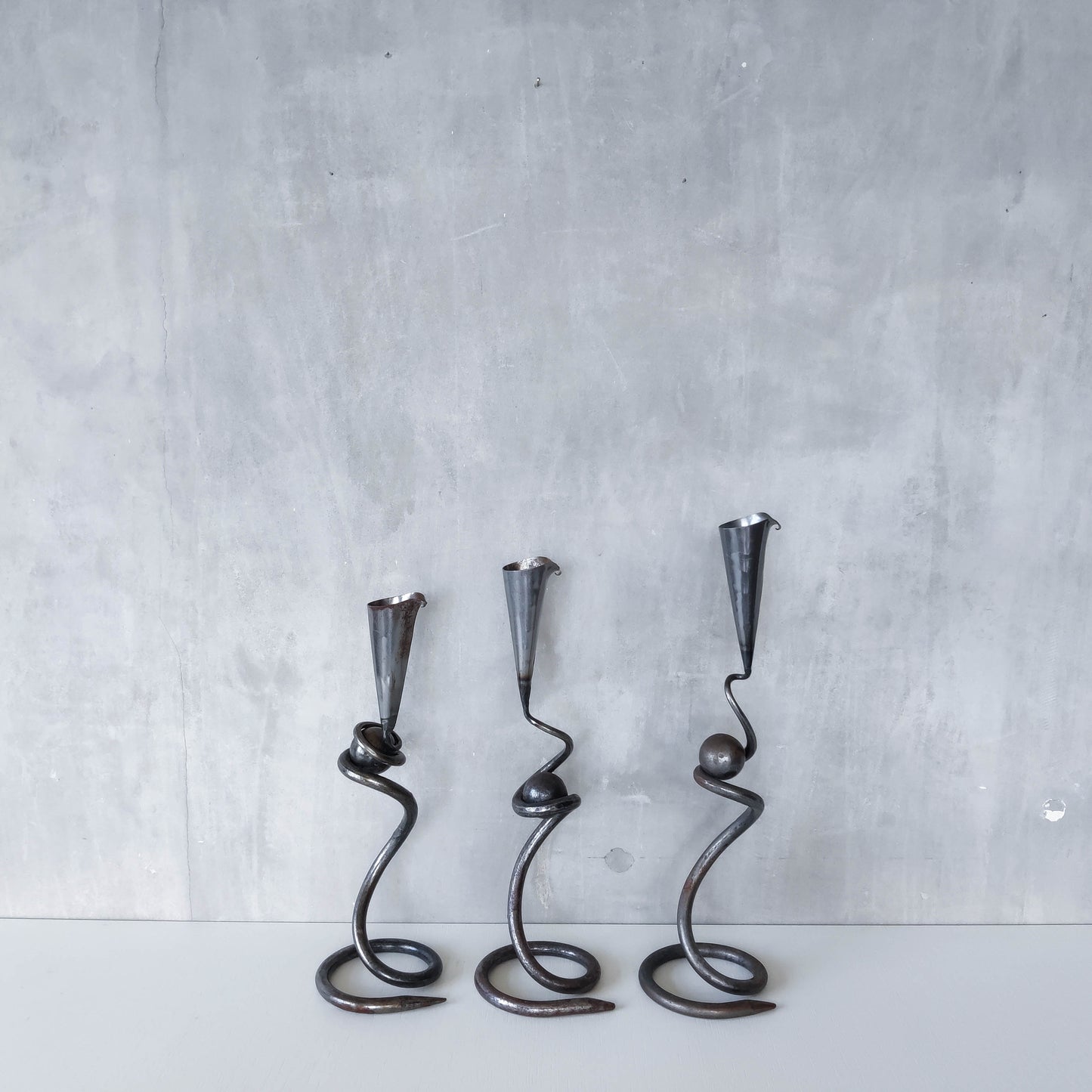 Trio of sculptural handmade wrought iron welded steel candle holders with steel balls