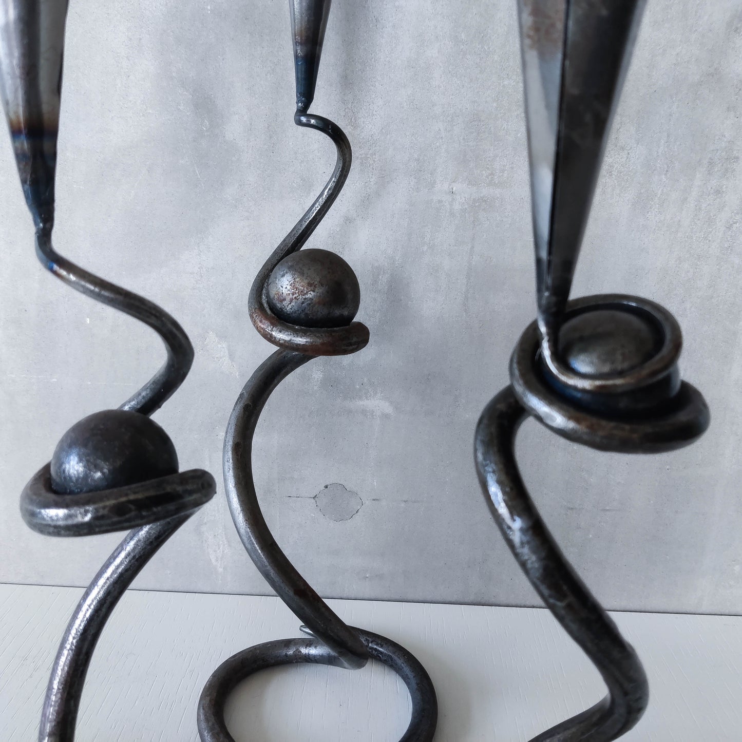 Trio of sculptural handmade wrought iron welded steel candle holders with steel balls