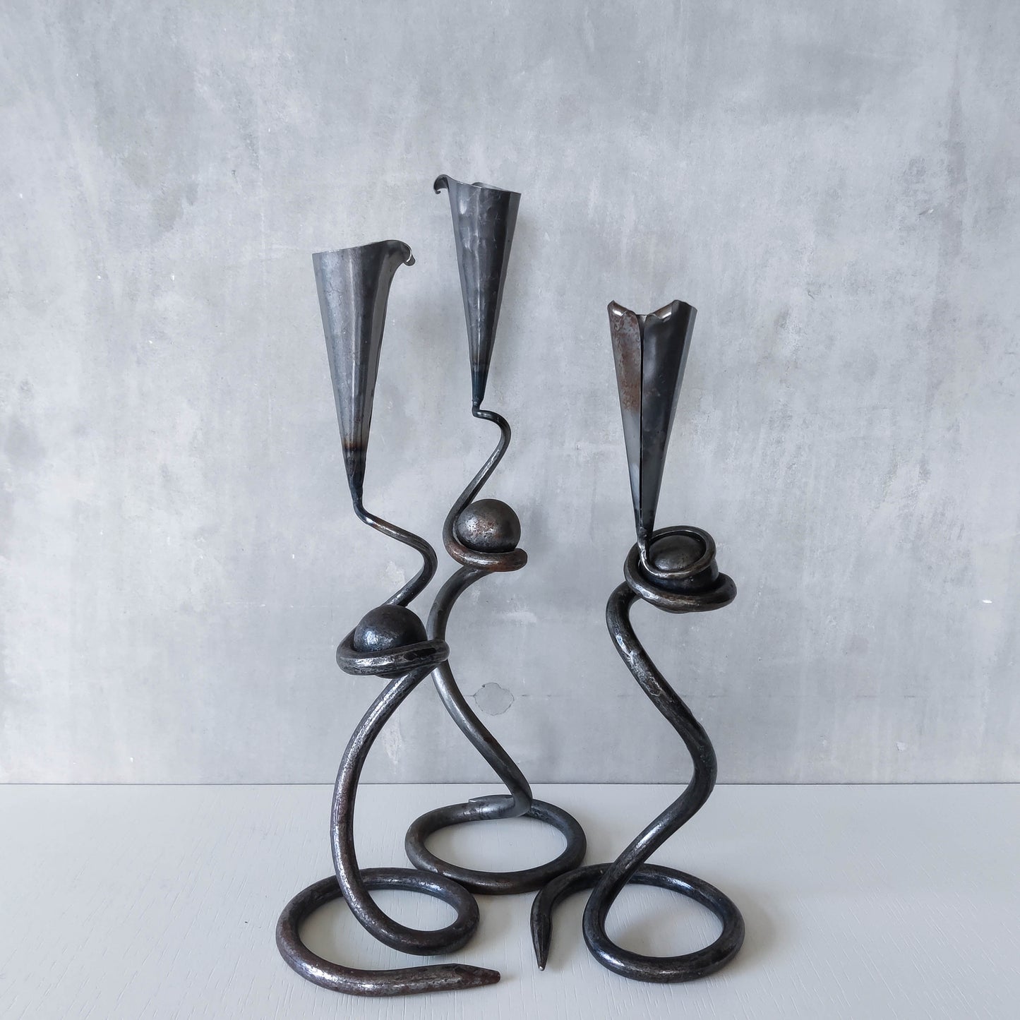 Trio of sculptural handmade wrought iron welded steel candle holders with steel balls