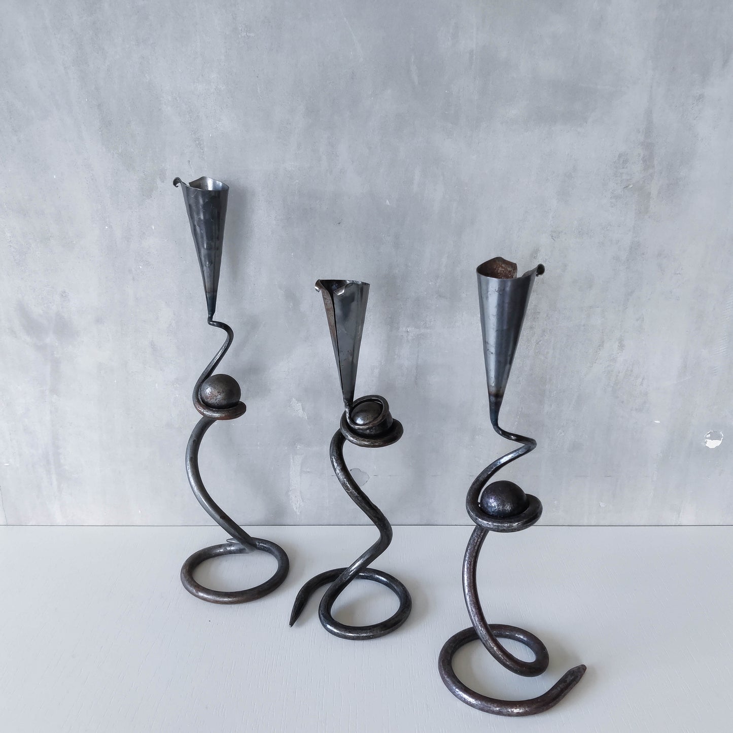 Trio of sculptural handmade wrought iron welded steel candle holders with steel balls