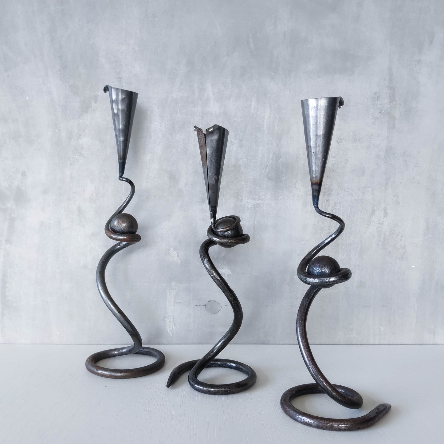 Trio of sculptural handmade wrought iron welded steel candle holders with steel balls