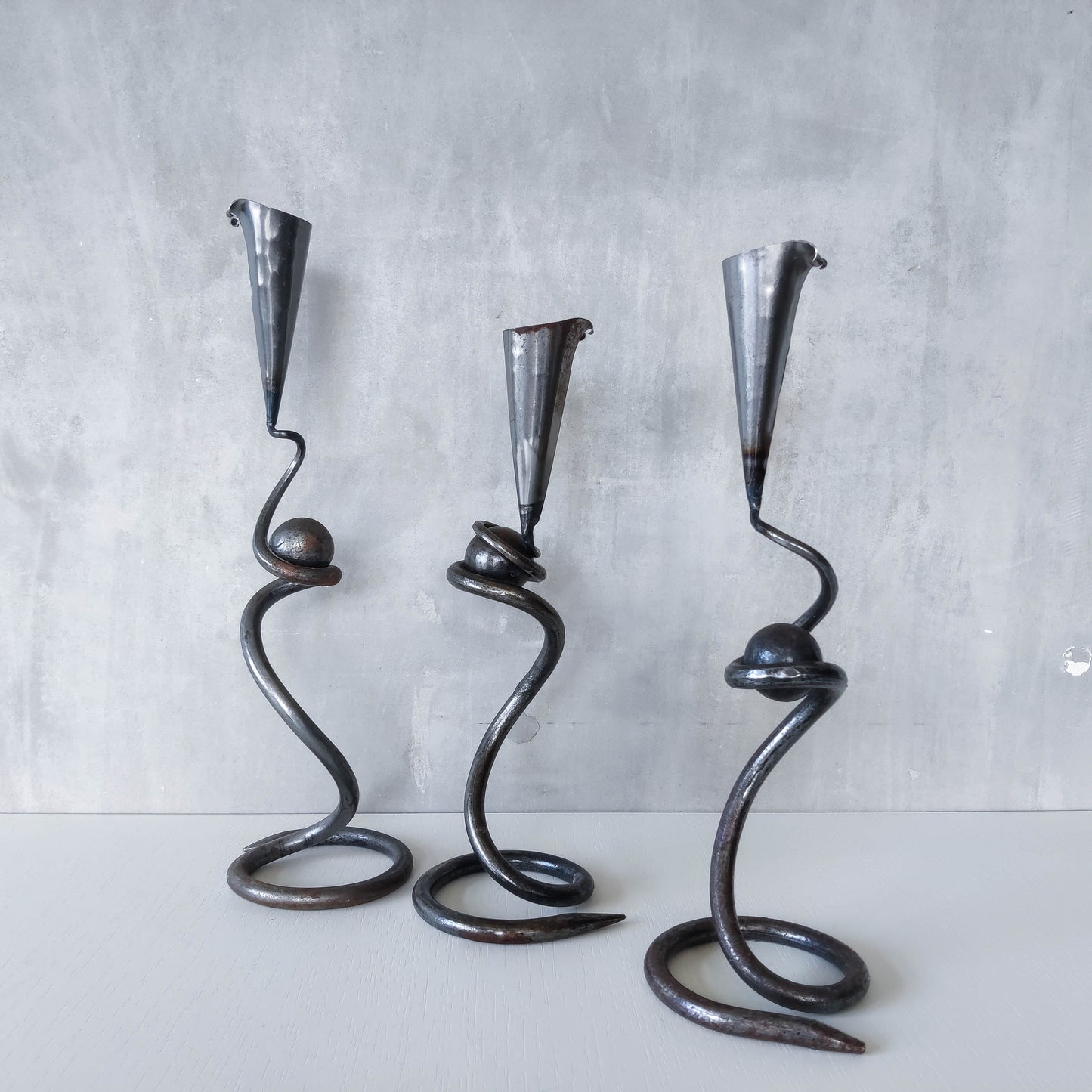 Trio of sculptural handmade wrought iron welded steel candle holders with steel balls