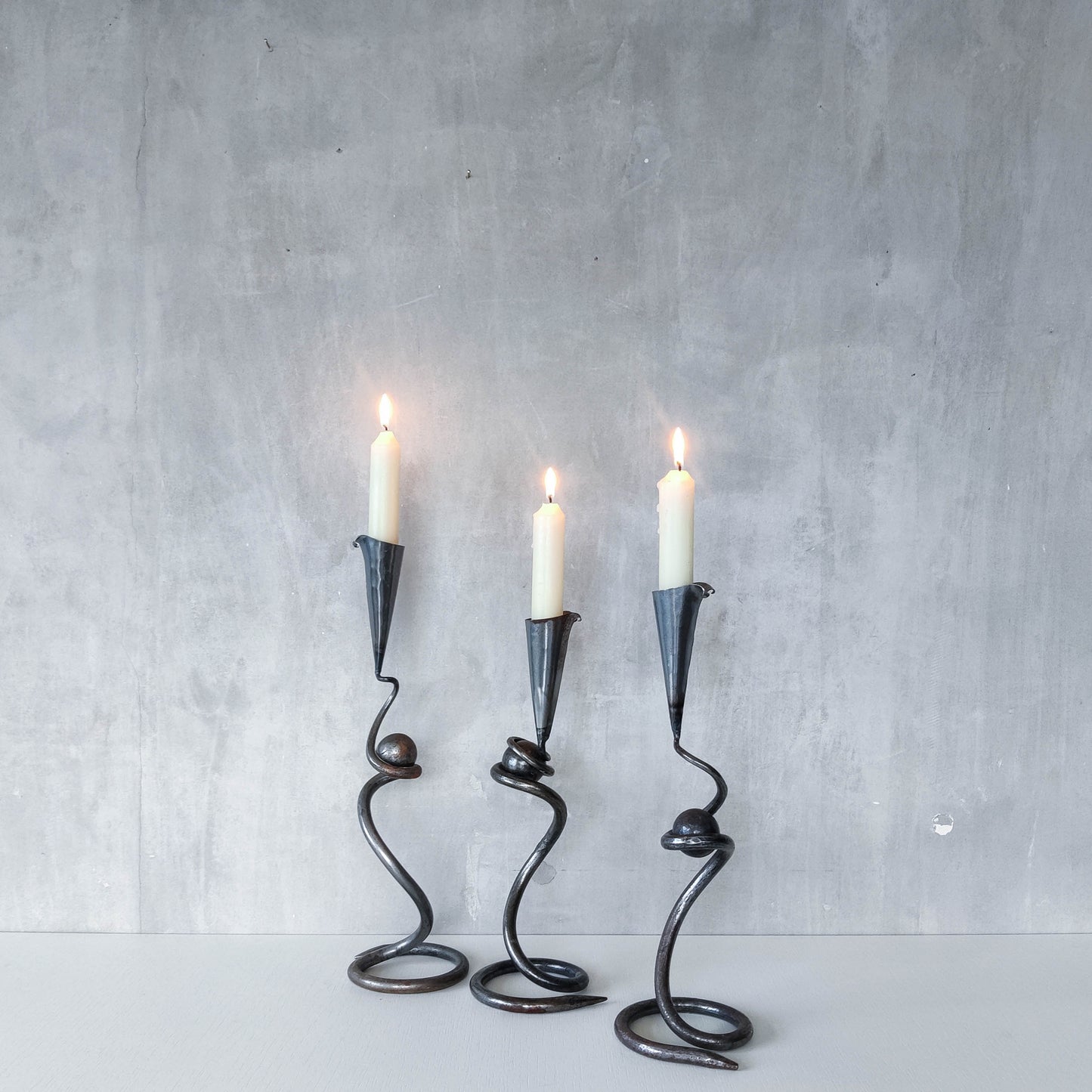 Trio of sculptural handmade wrought iron welded steel candle holders with steel balls
