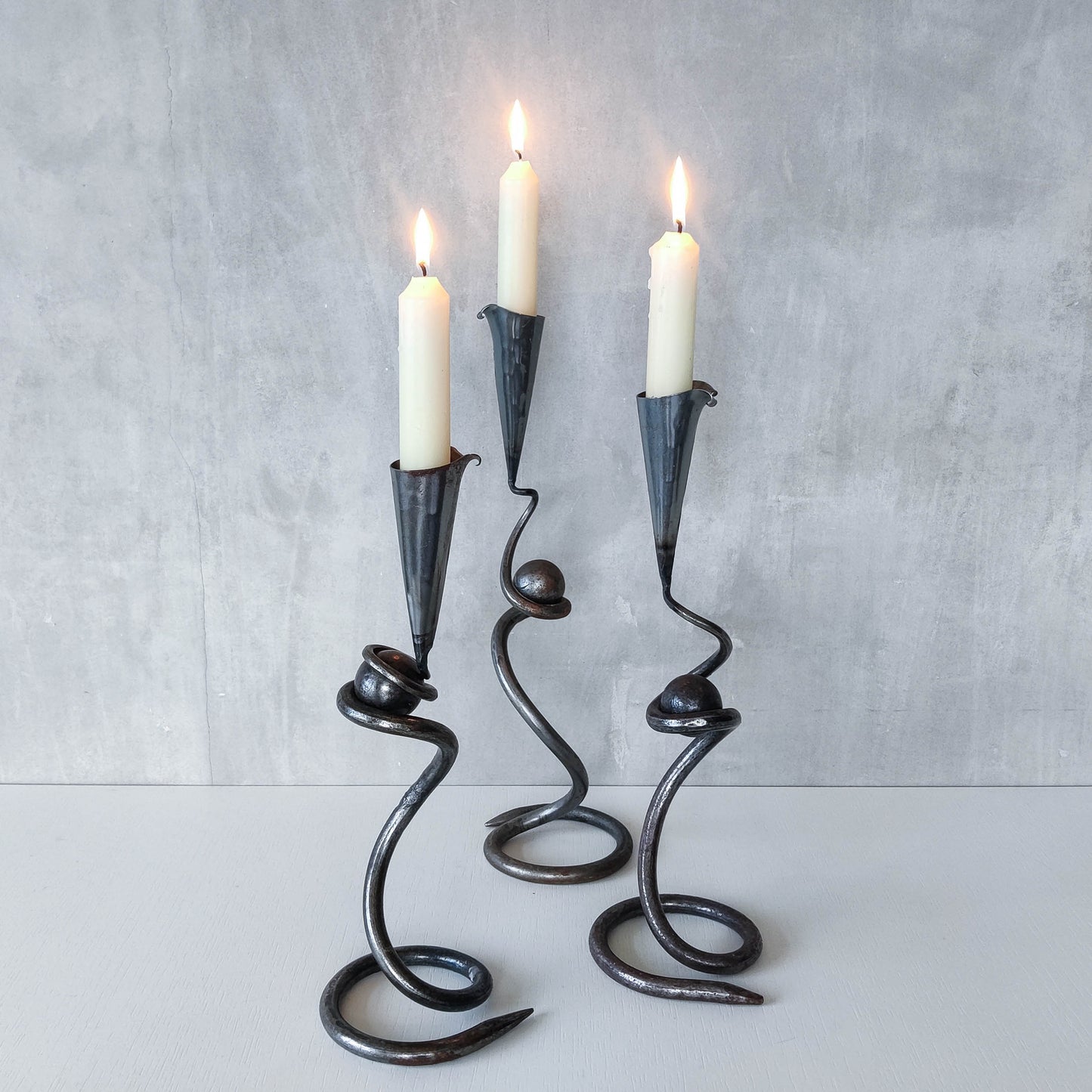 Trio of sculptural handmade wrought iron welded steel candle holders with steel balls
