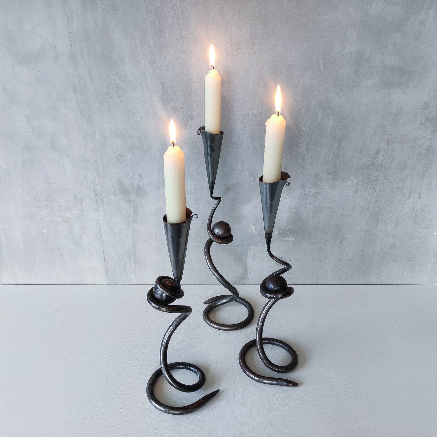 Trio of sculptural handmade wrought iron welded steel candle holders with steel balls