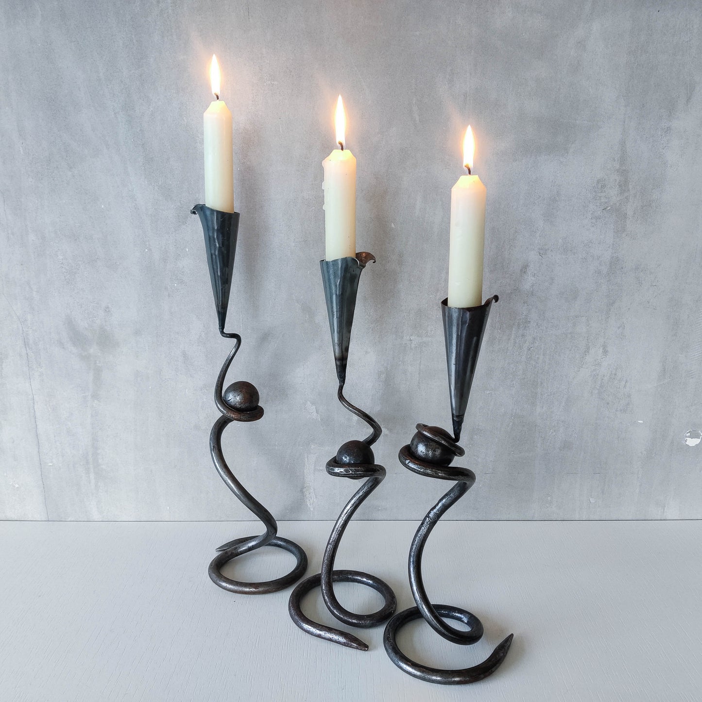 Trio of sculptural handmade wrought iron welded steel candle holders with steel balls